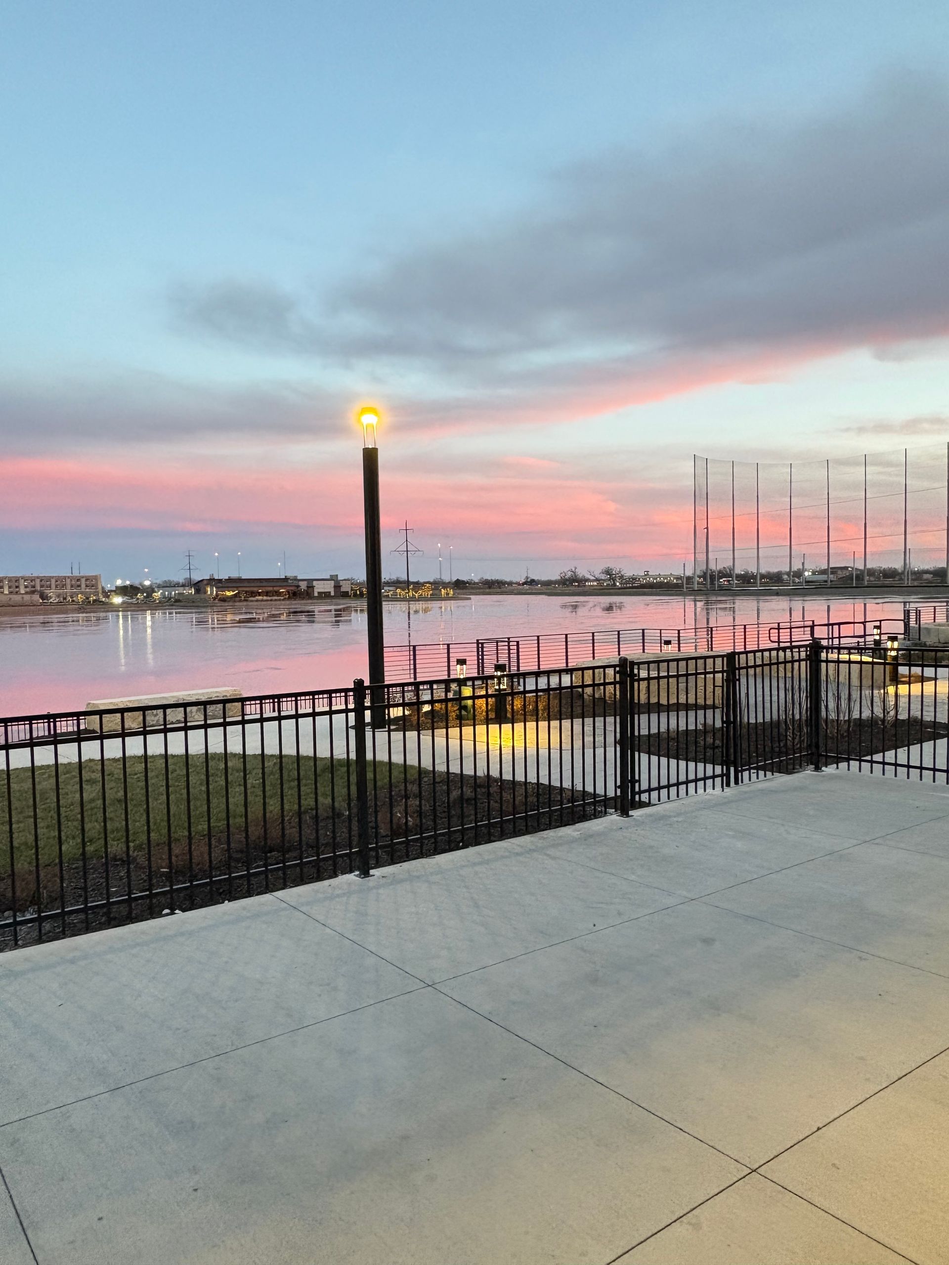 Two stemmed glasses filled with white wine, close-up, reflecting a blurry background.