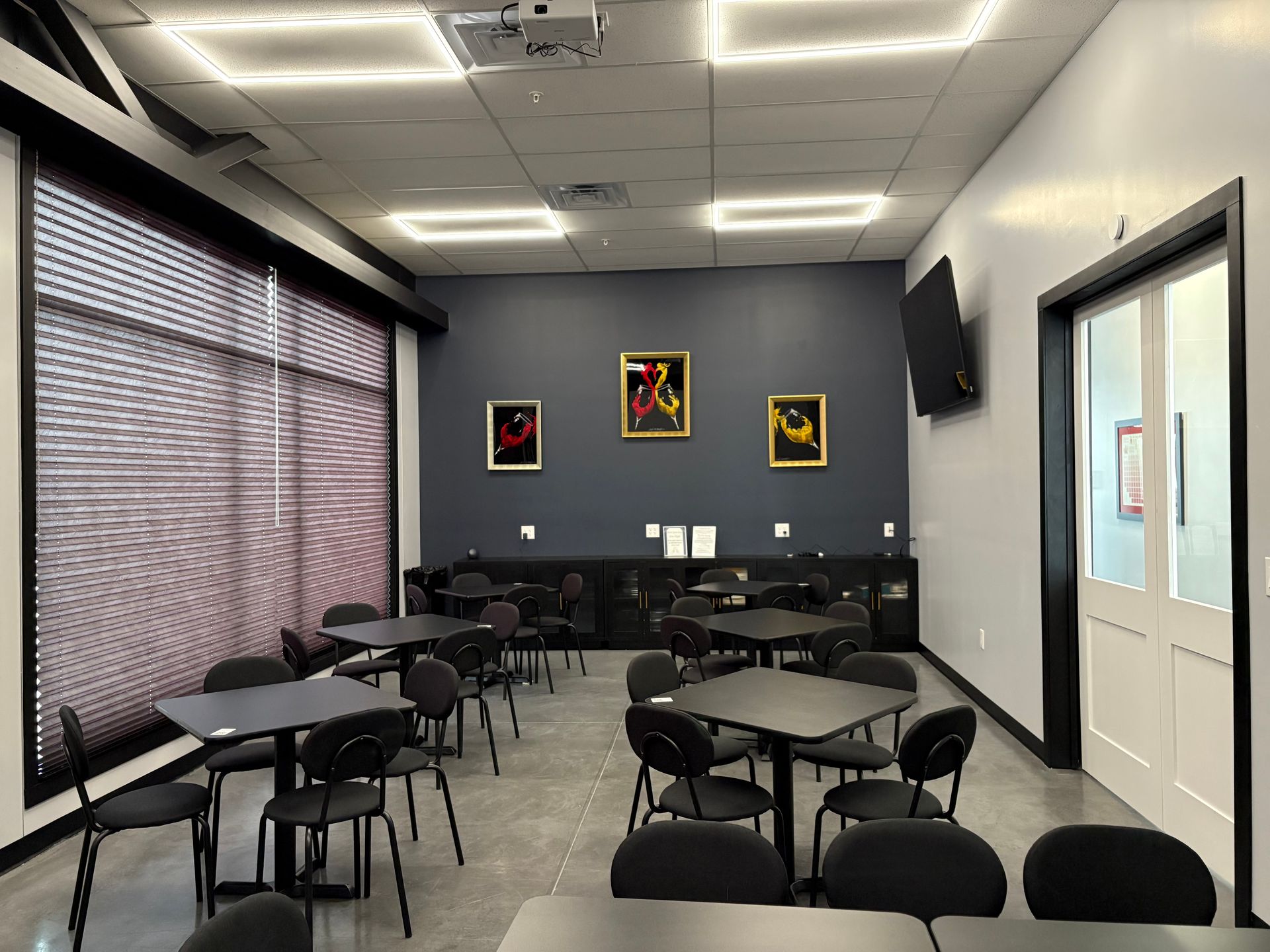 Charcuterie board with salami, cheese, olives, and wine on a mosaic table.