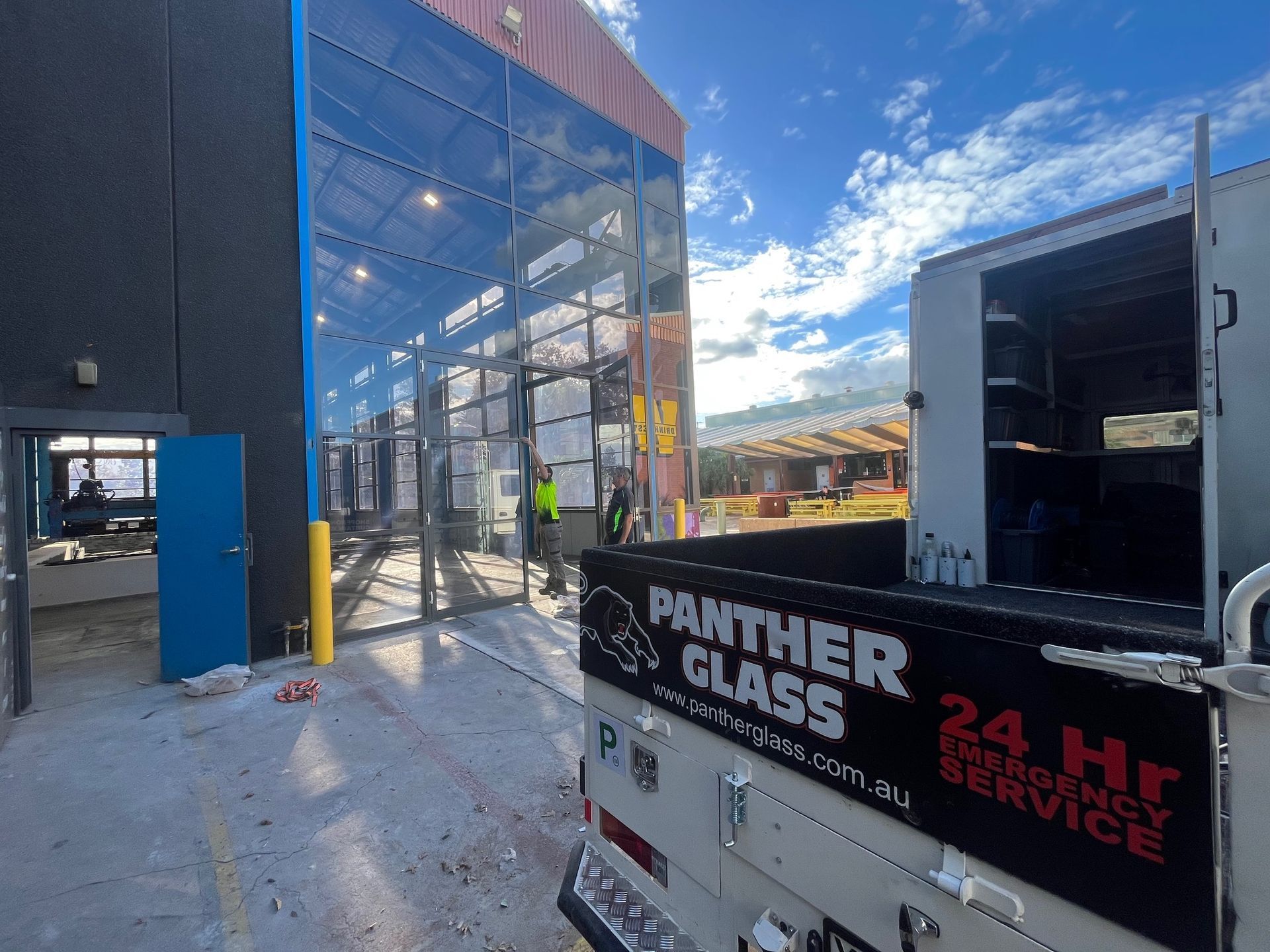 A panther glass truck is parked in front of a building — Penrith, NSW — Panther Glass & Aluminum