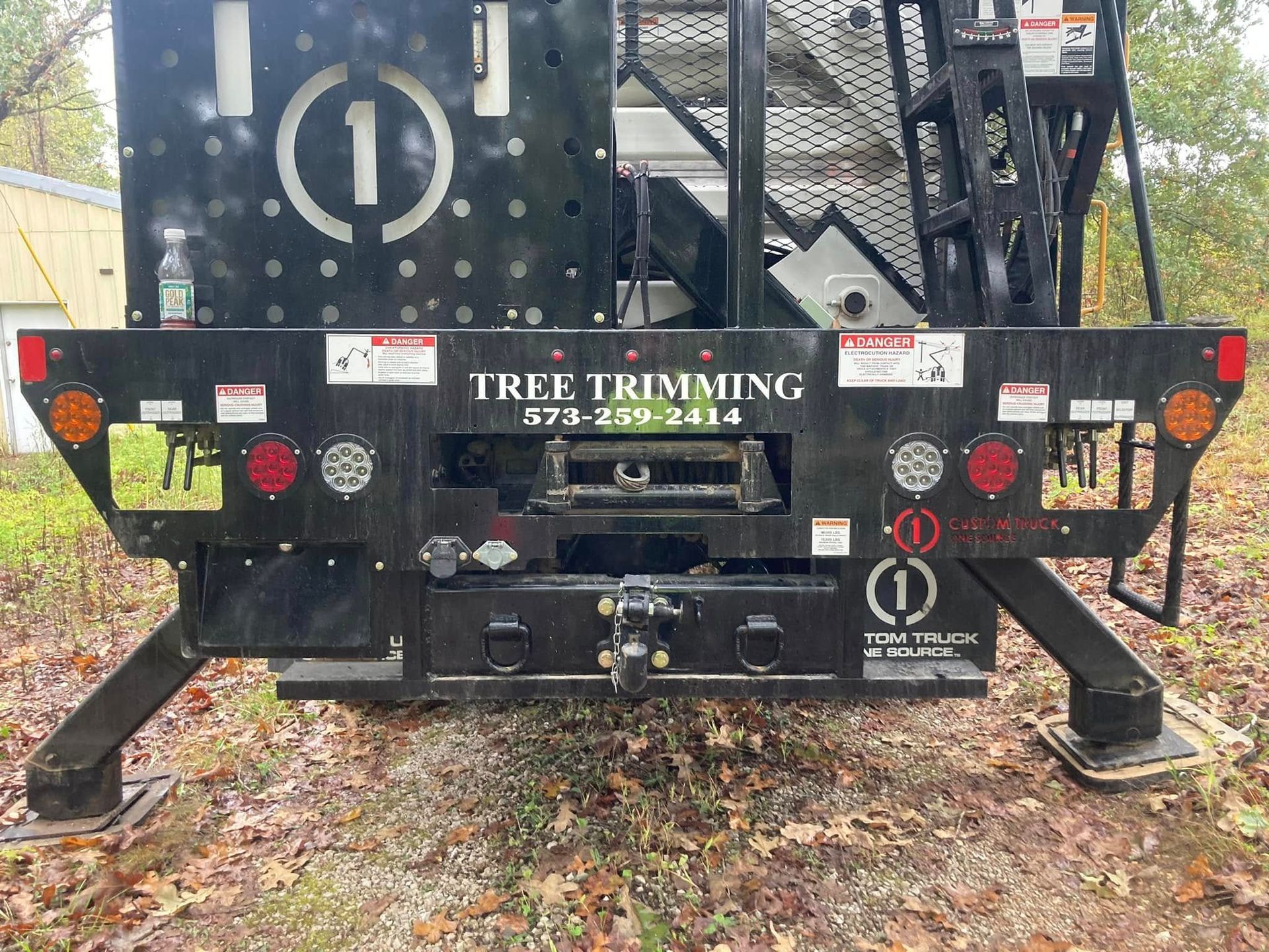The back of a tree trimming truck is shown.