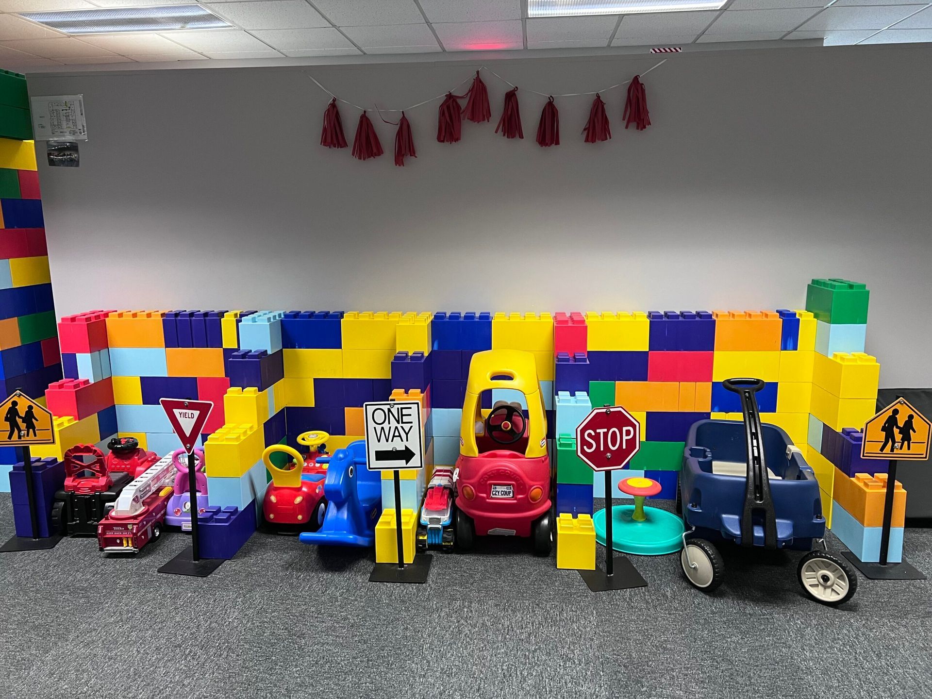 A room filled with lots of colorful lego blocks and toy cars.