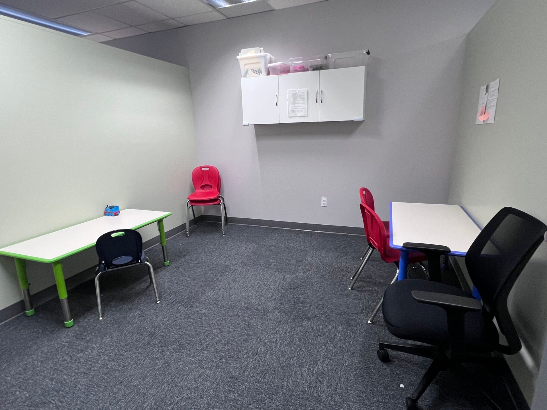 A room with tables and chairs in it.