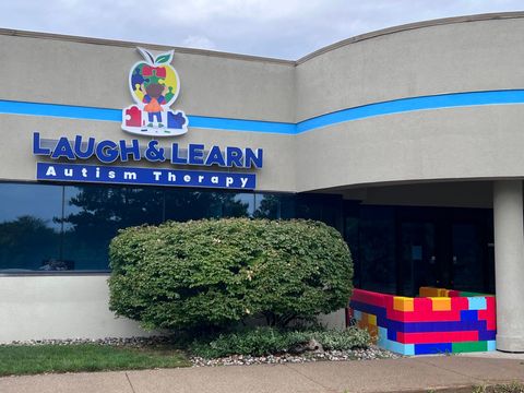 A building with a sign that says laugh and learn autism therapy