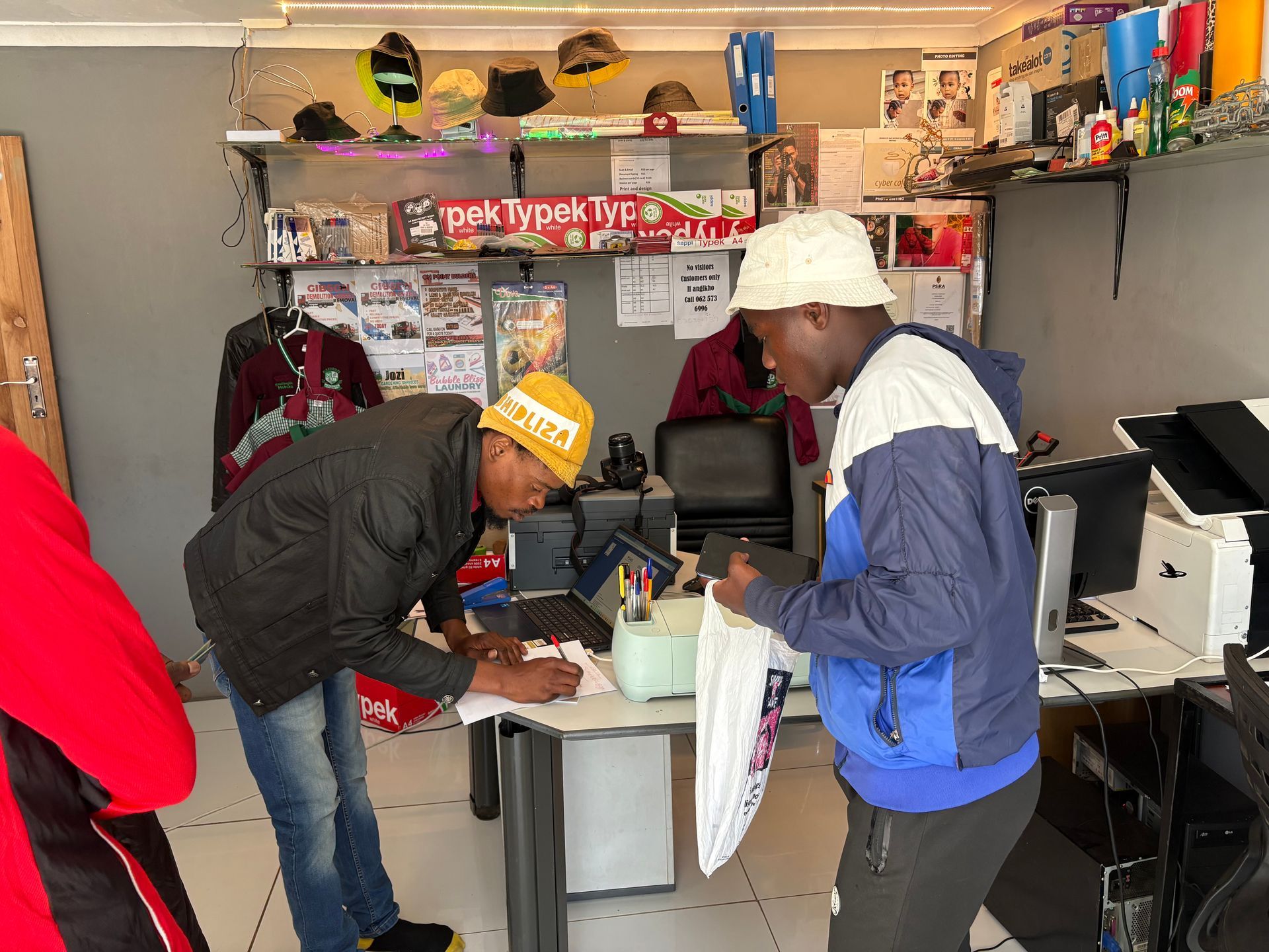 A group of men are standing around a table in a room.