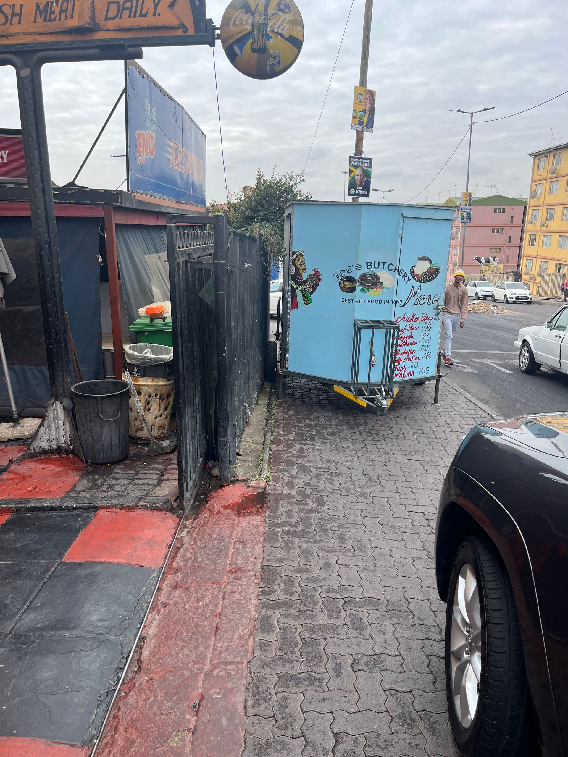 A black car is parked on the side of the road