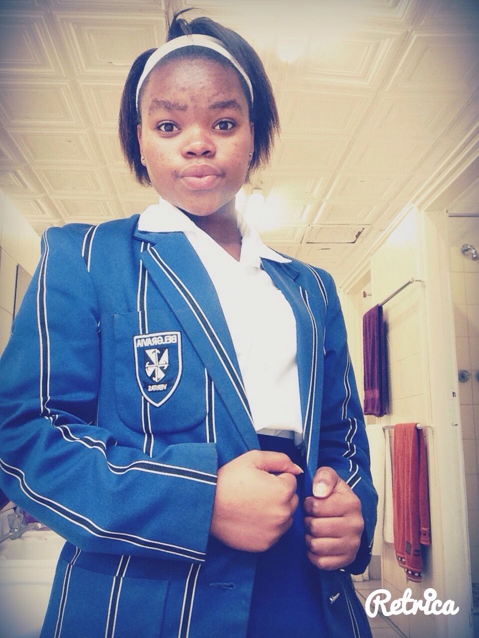 A girl wearing a blue jacket with a cross on it