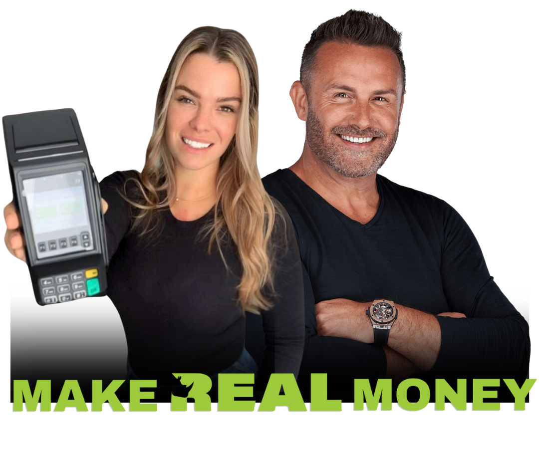 A man and a woman standing next to each other holding a machine that says make real money