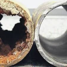 A close up of a rusty pipe next to a clean pipe.