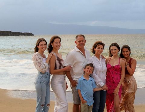 Dr. Karen Architect  is standing in front of a sign that says heart healthy family practice.