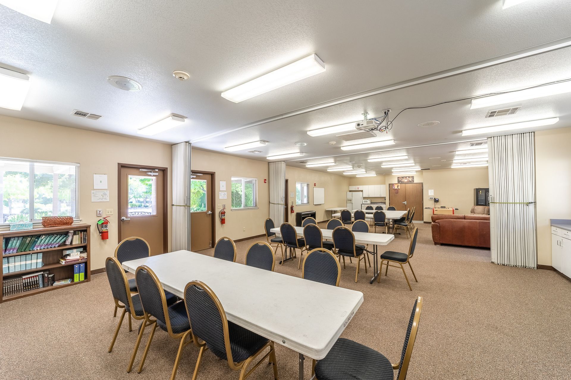 A large room with tables and chairs in it.