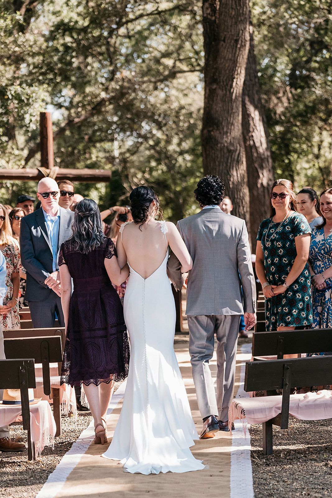 A bride and groom are walking down the aisle at their wedding.