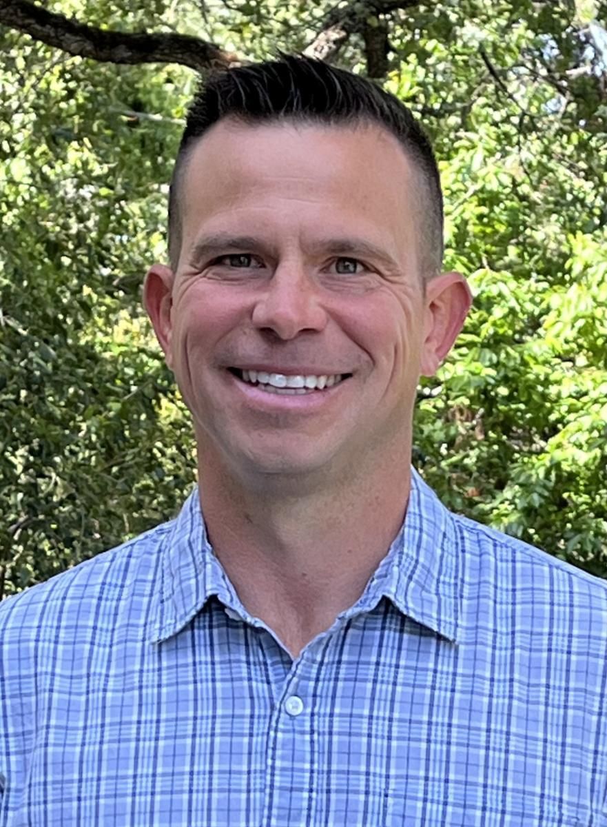 Nate Calhoun is smiling for the camera.