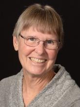 Kim is smiling for the camera.