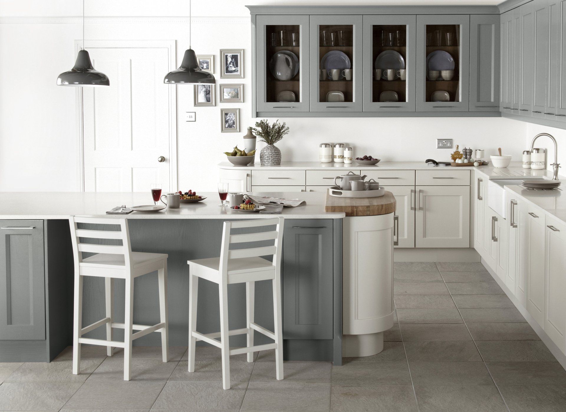 Kew Putty and Mink Kitchen glass wall units displaying crockery and island with painted wooden bar stools