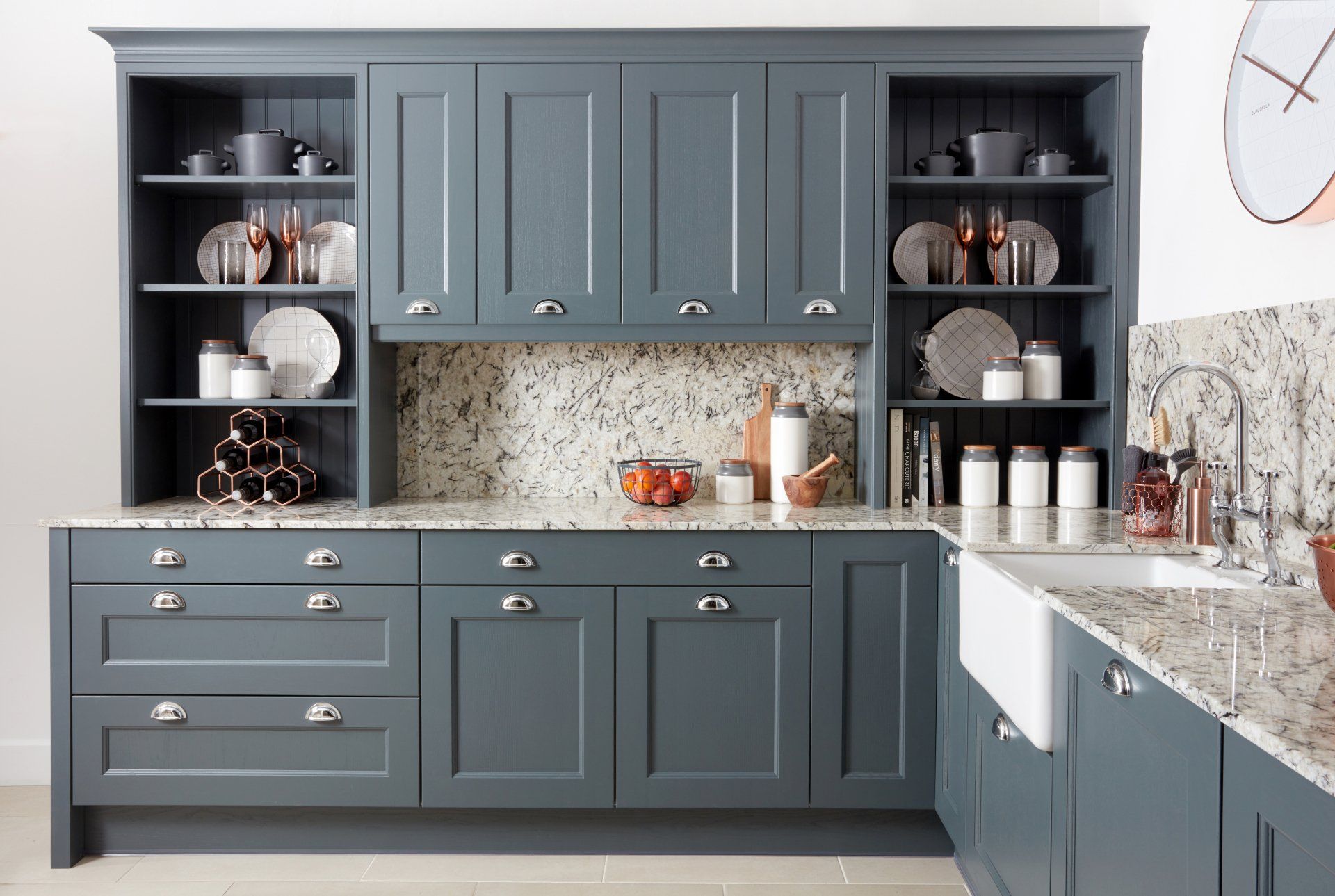 Finsbury dark painted kitchen with open shelves either side of wall units and arctic white granite worktop and splashback