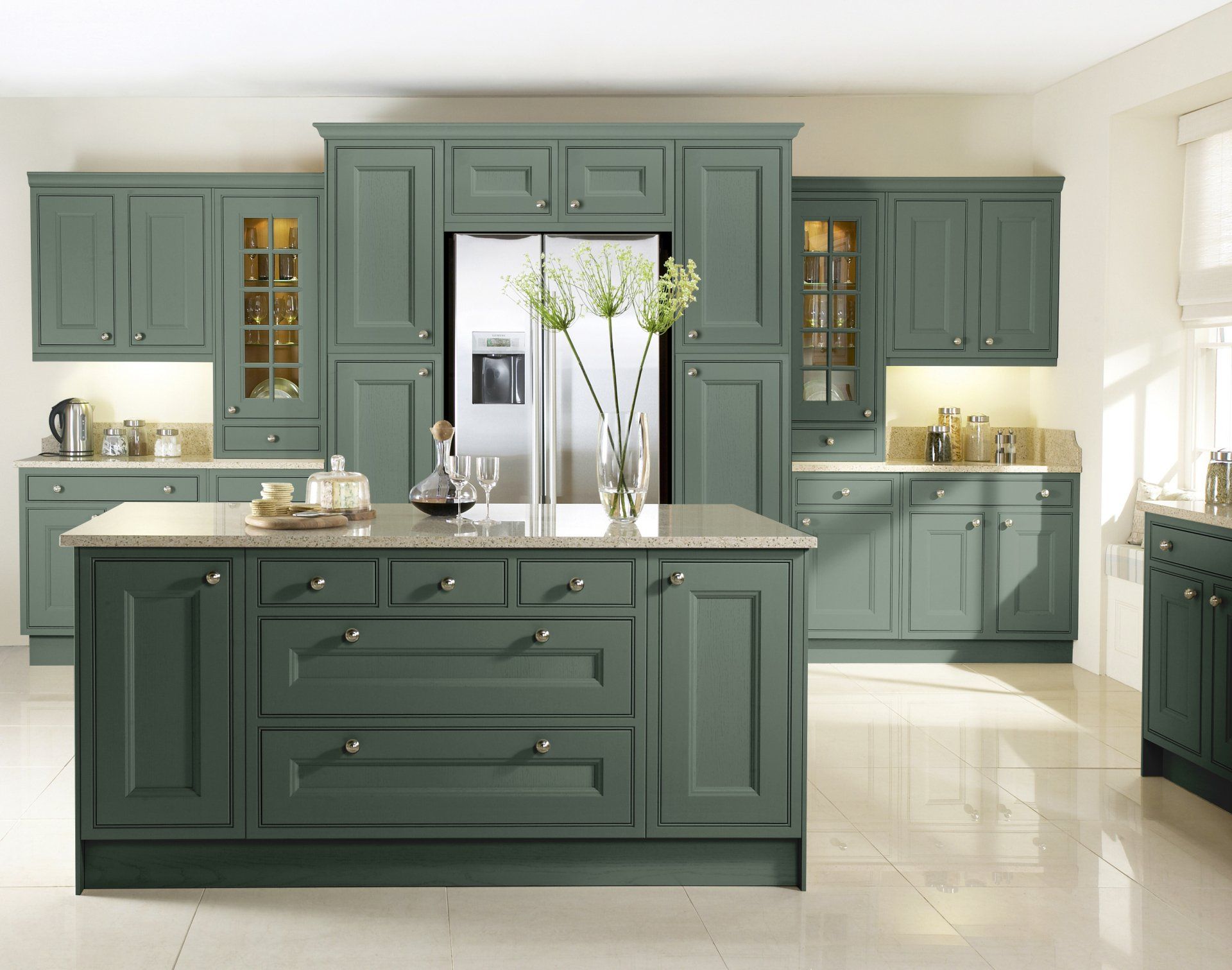 Tetbury Thyme Kitchen American fridge freezer behind the island, island contains drawer pack and doors, large vase  with tall flowers