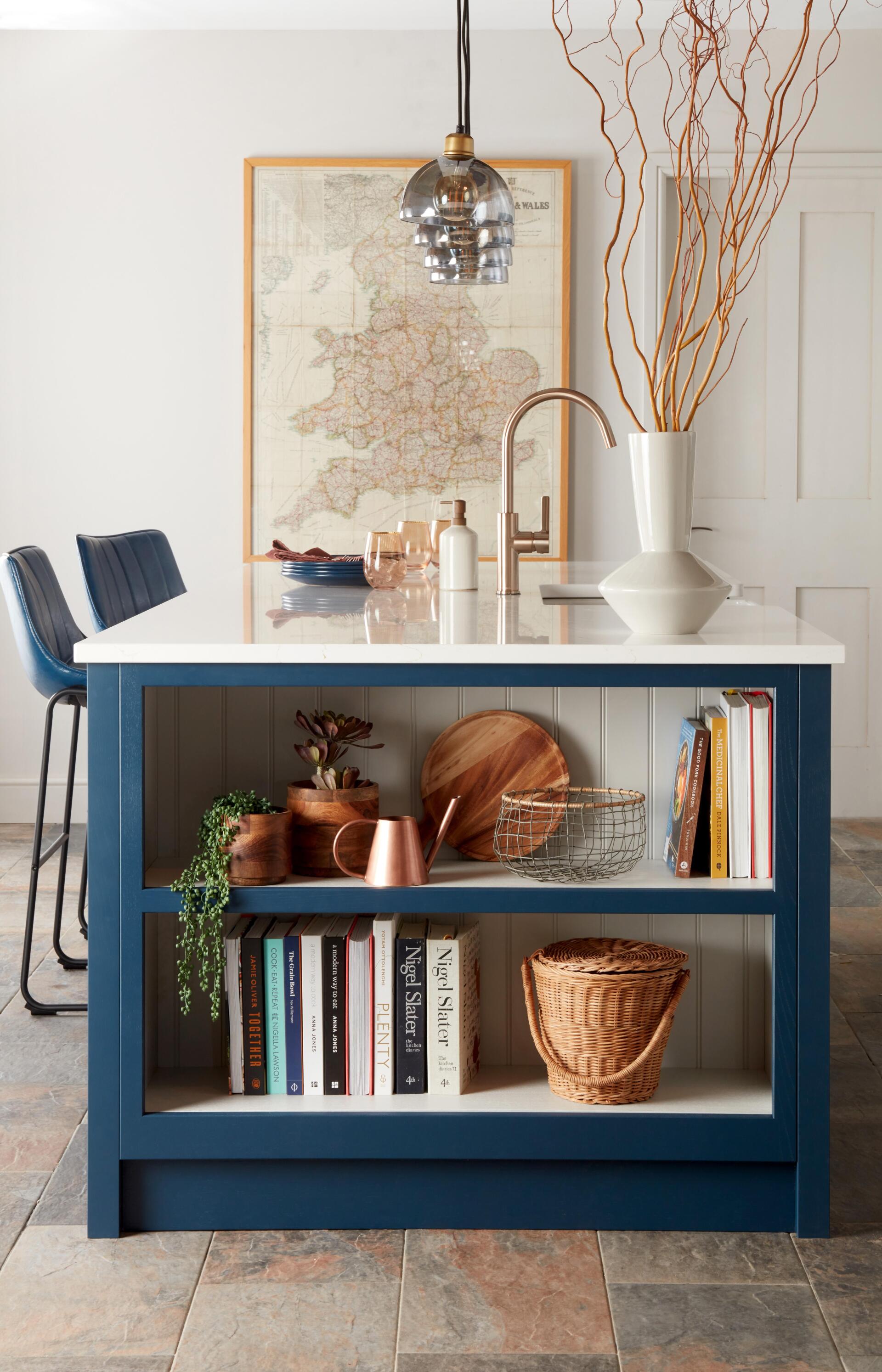 Pembury Prussian Blue Kitchen with t&g painted putty open island unit with cookery books, wooden vase and old england map