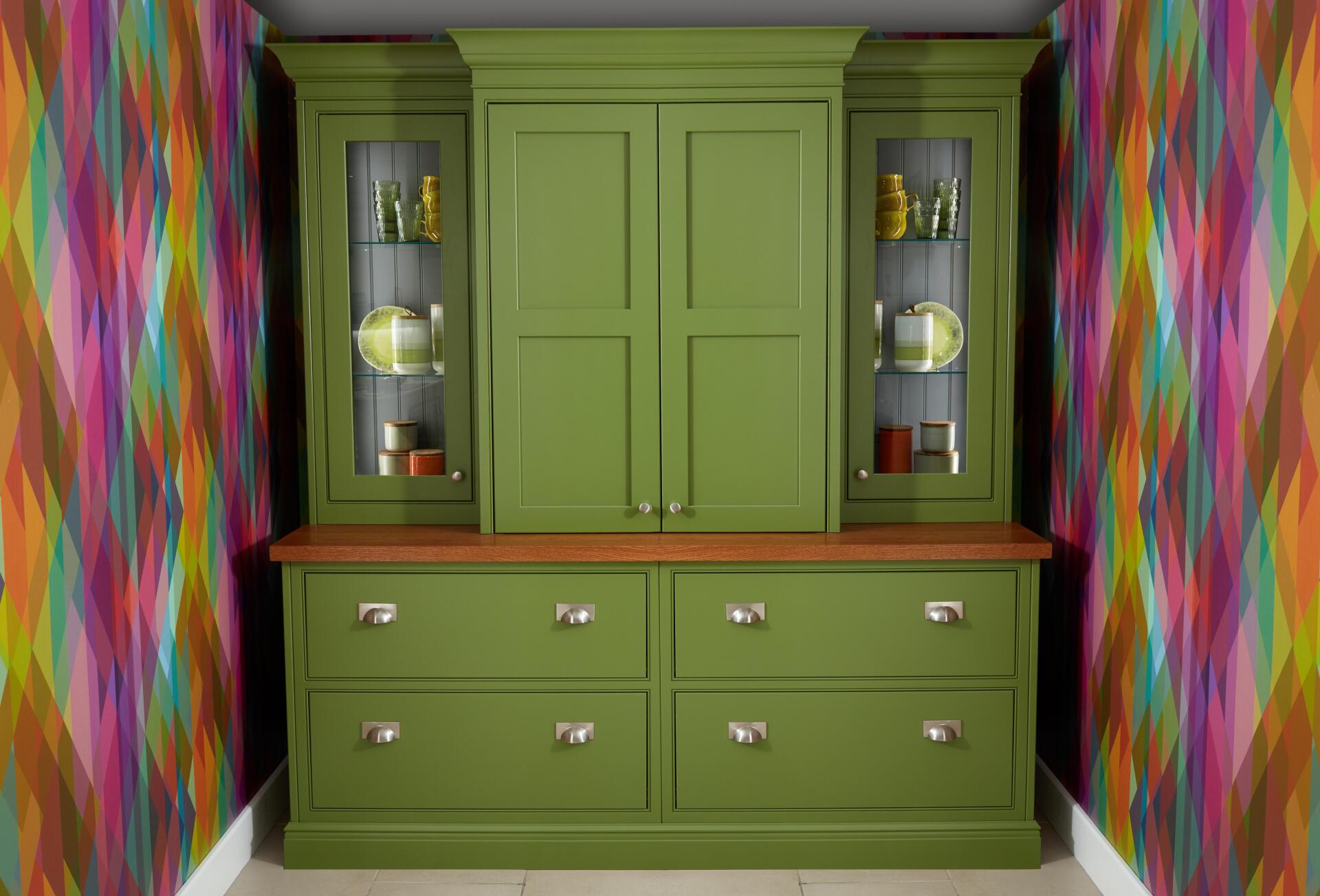Funky coloured wallpaper and bright green dresser