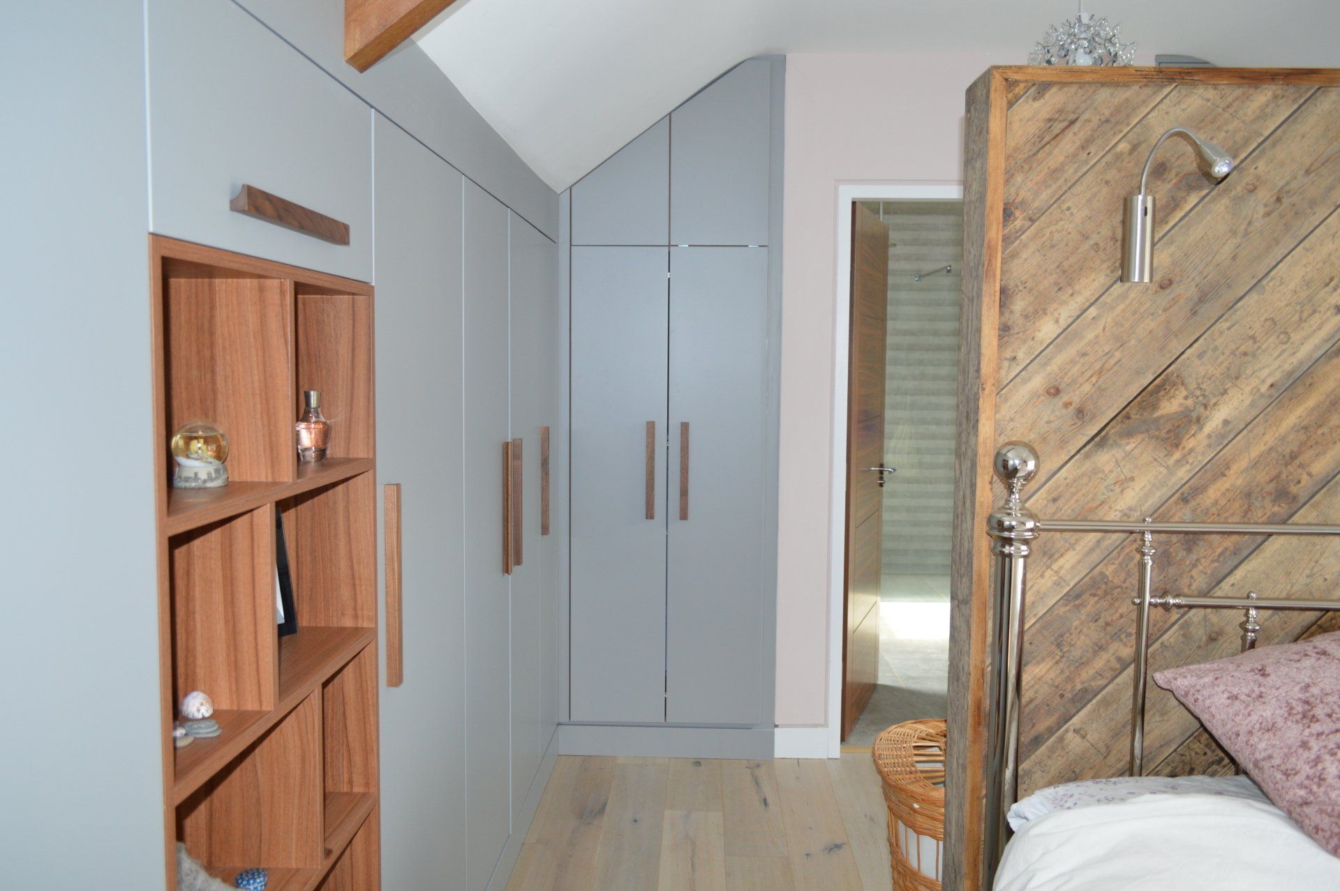 Grey Painted Wardrobe shaped to ceiling with walnut handle and open units with chandelier