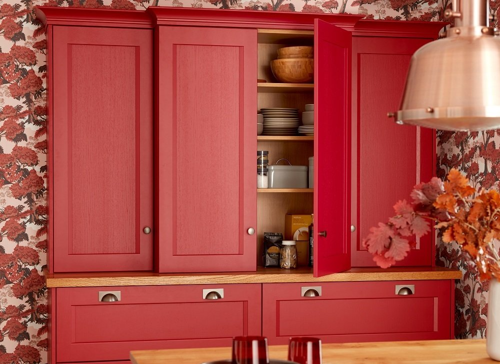 Painted Red Kitchen Larder with Wooden worktop and bright flower wallpaper