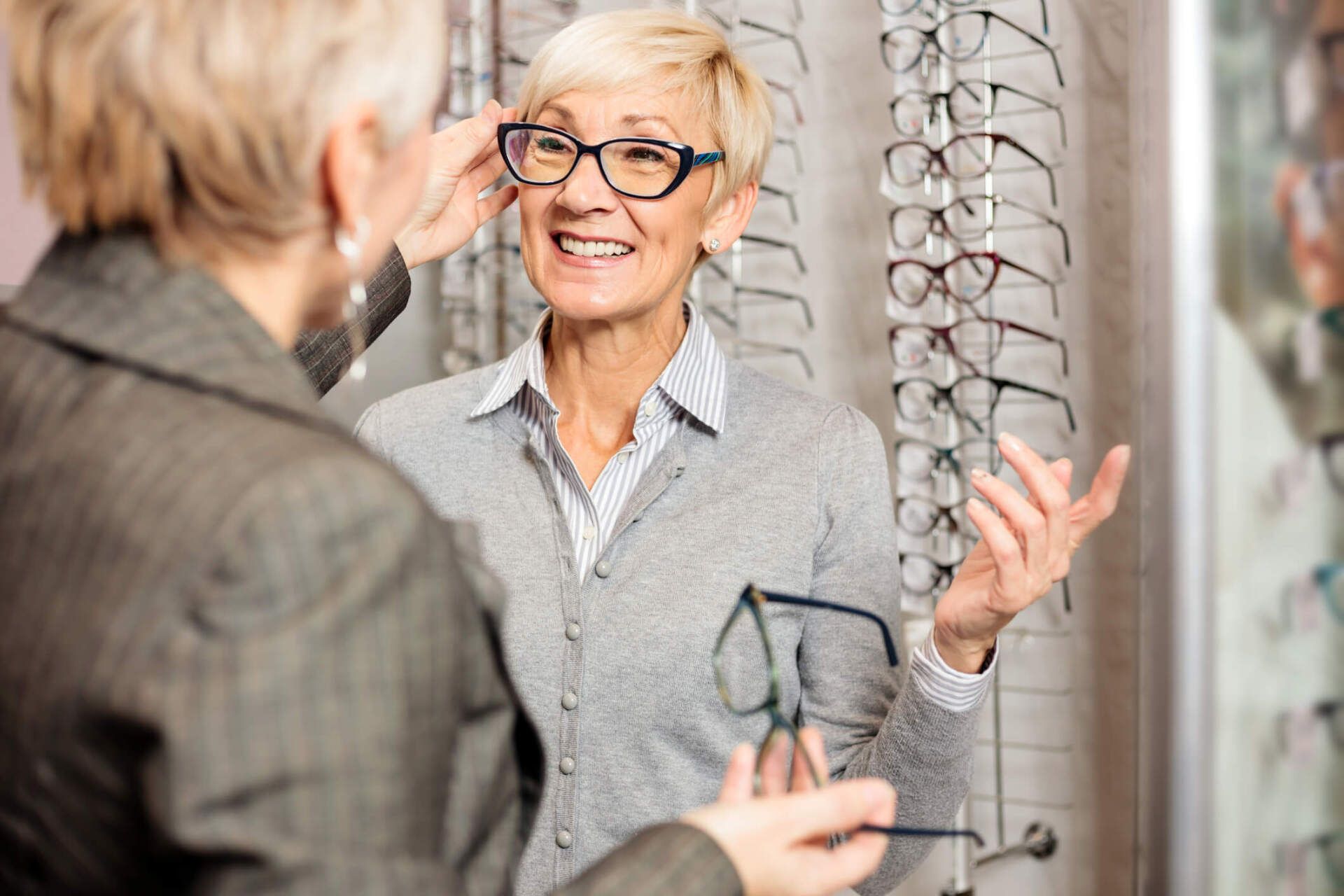 Seller Helping Senior Woman to Choose Glasses — Orange, MA — Leonard Optician Inc.