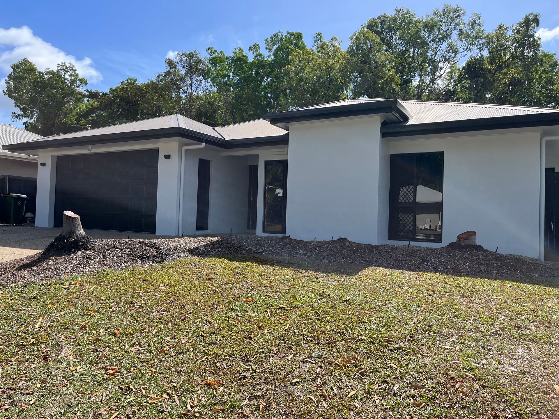 A large white house with a porch and a white fence