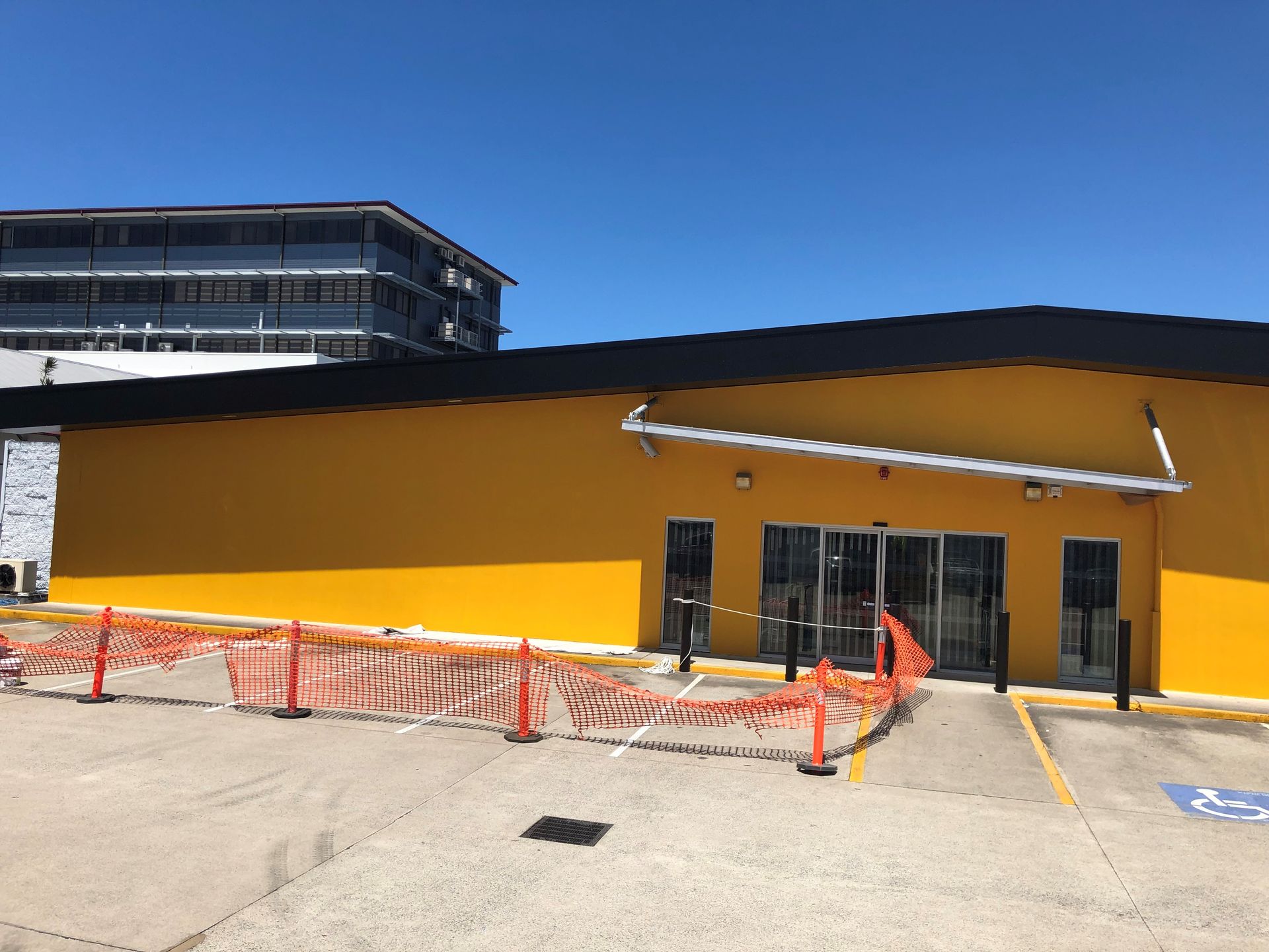 A man in a protective suit is painting a wall on a lift.