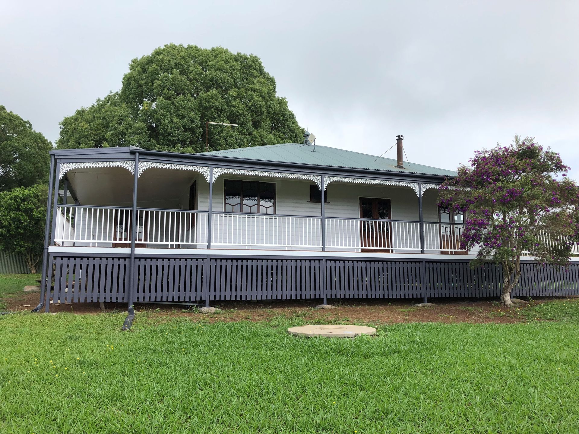 A man wearing a hard hat is painting a wall with a roller.
