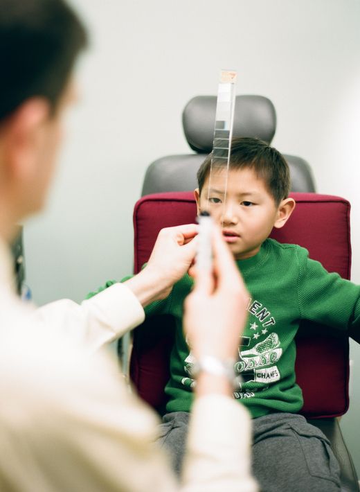 boy smiling and wearing eye test goggles