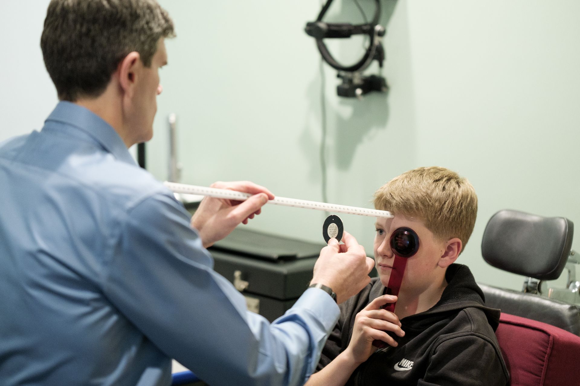 boy smiling and wearing eye test goggles