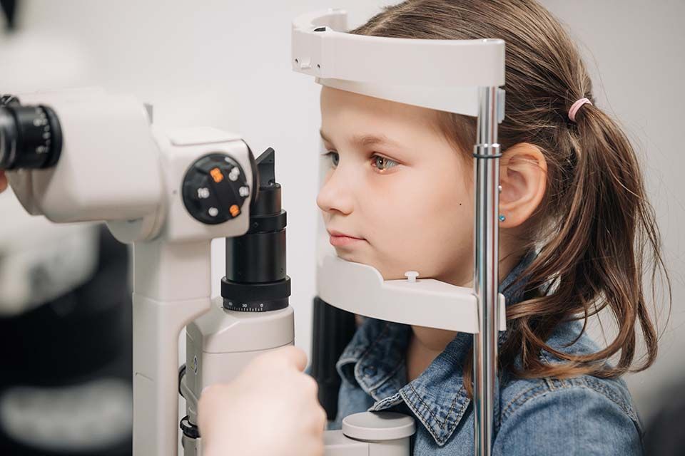 girl in brace receiving eye test