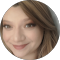 A close up of a woman 's face in a circle on a white background.