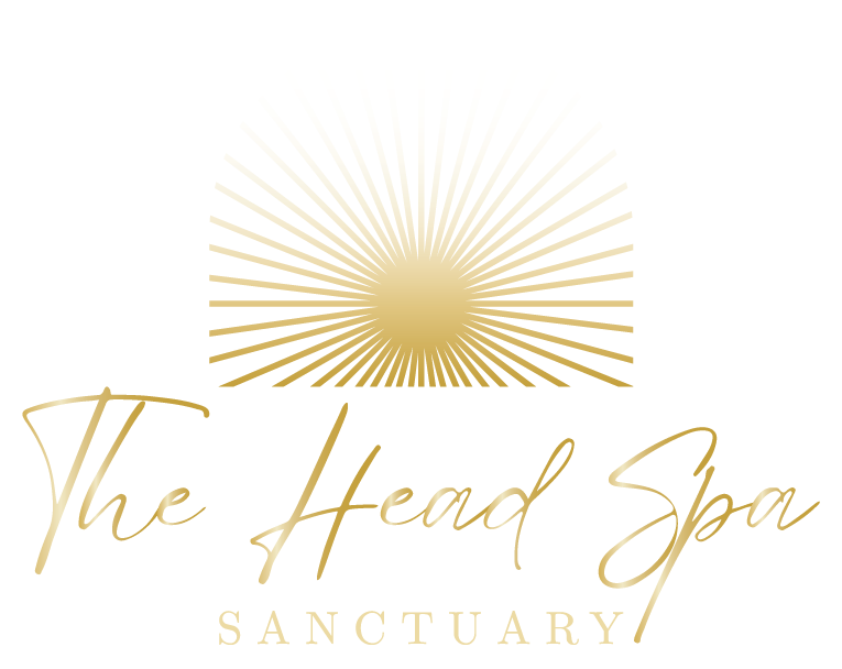 The logo for the head spa sanctuary is a gold sun with rays coming out of it.