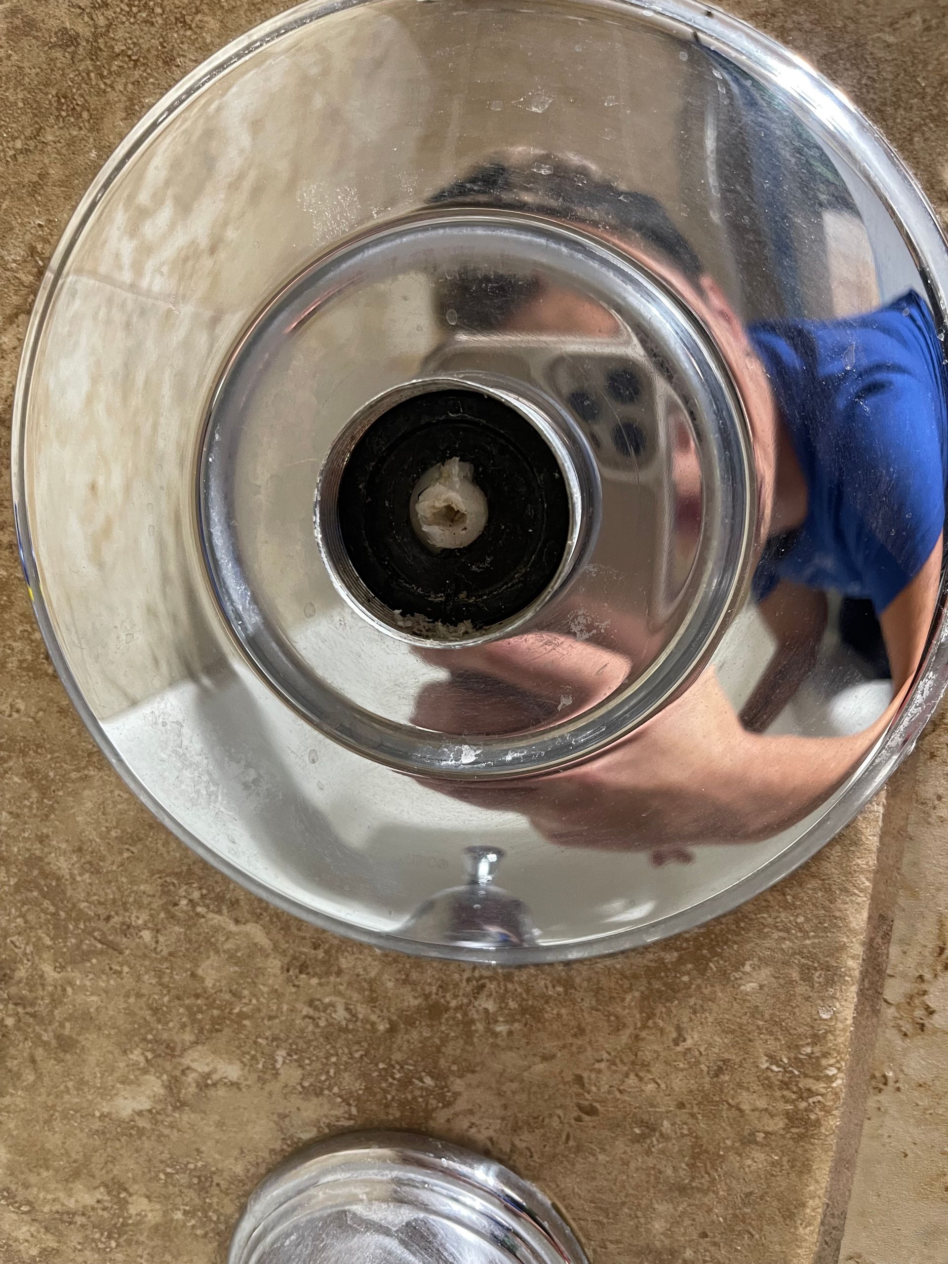 A person is taking a selfie in a bathroom mirror.