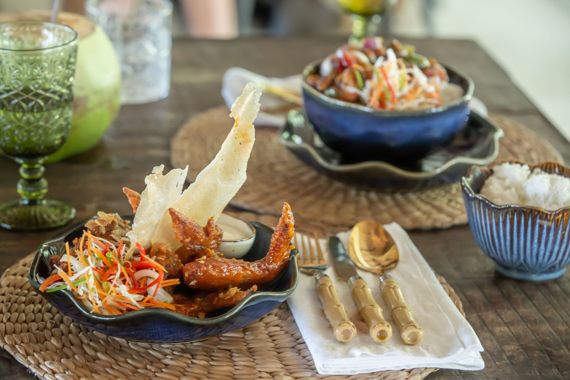 A table topped with plates of food and bowls of rice.