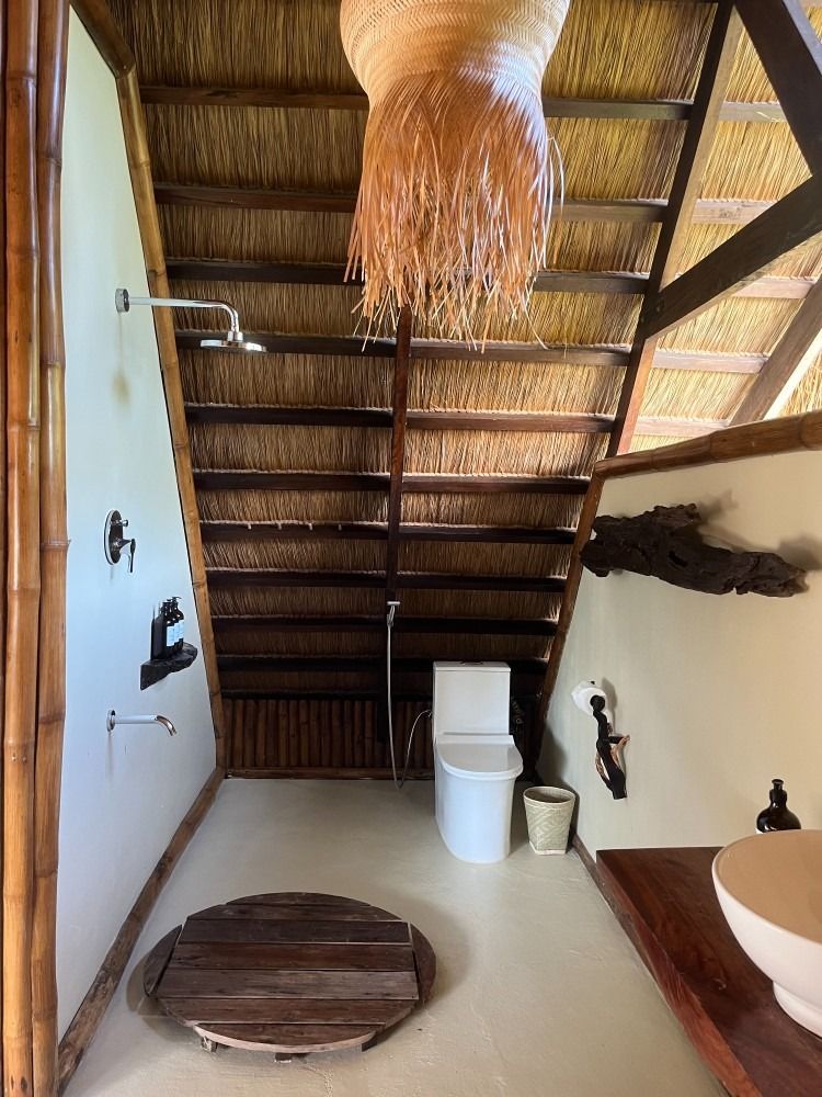 A bathroom with a toilet , sink , and shower.