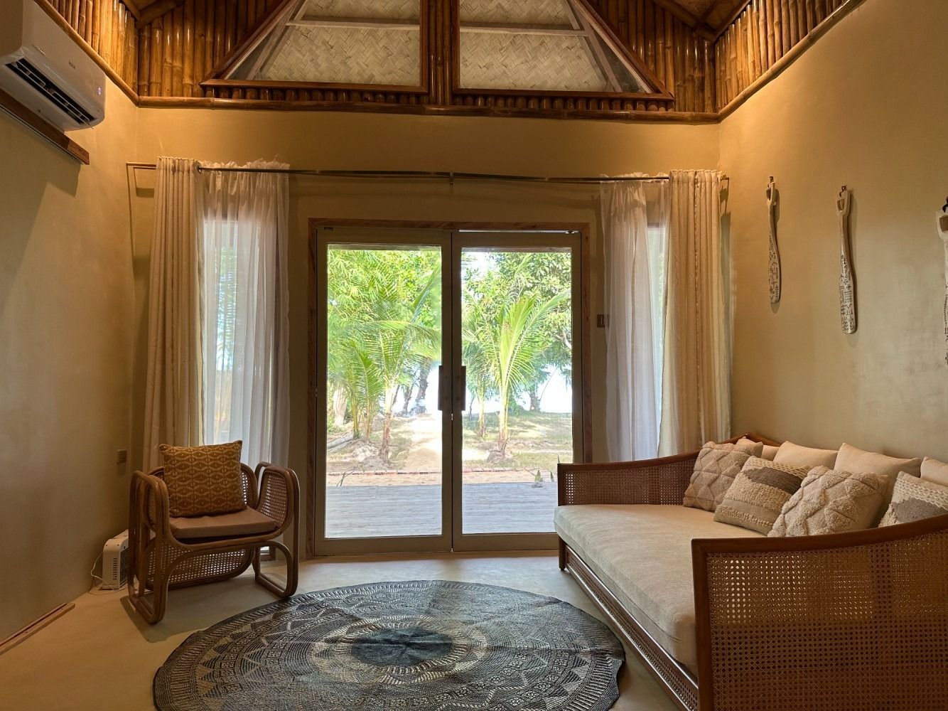 A living room with a couch , chair , and sliding glass doors.