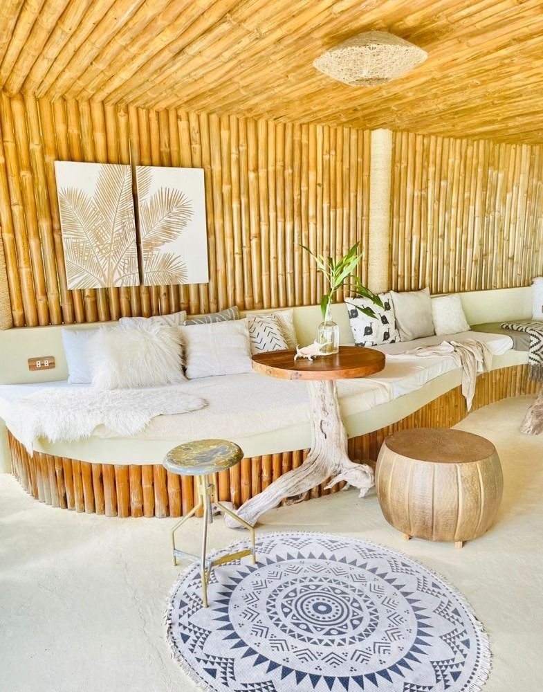 A living room with a round couch and a round rug.