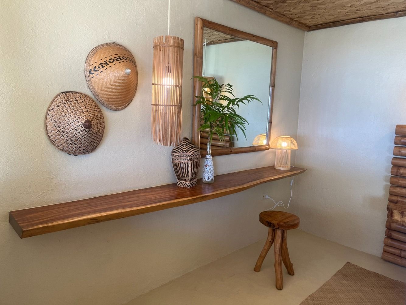 A wooden shelf with a mirror and a stool in a room.