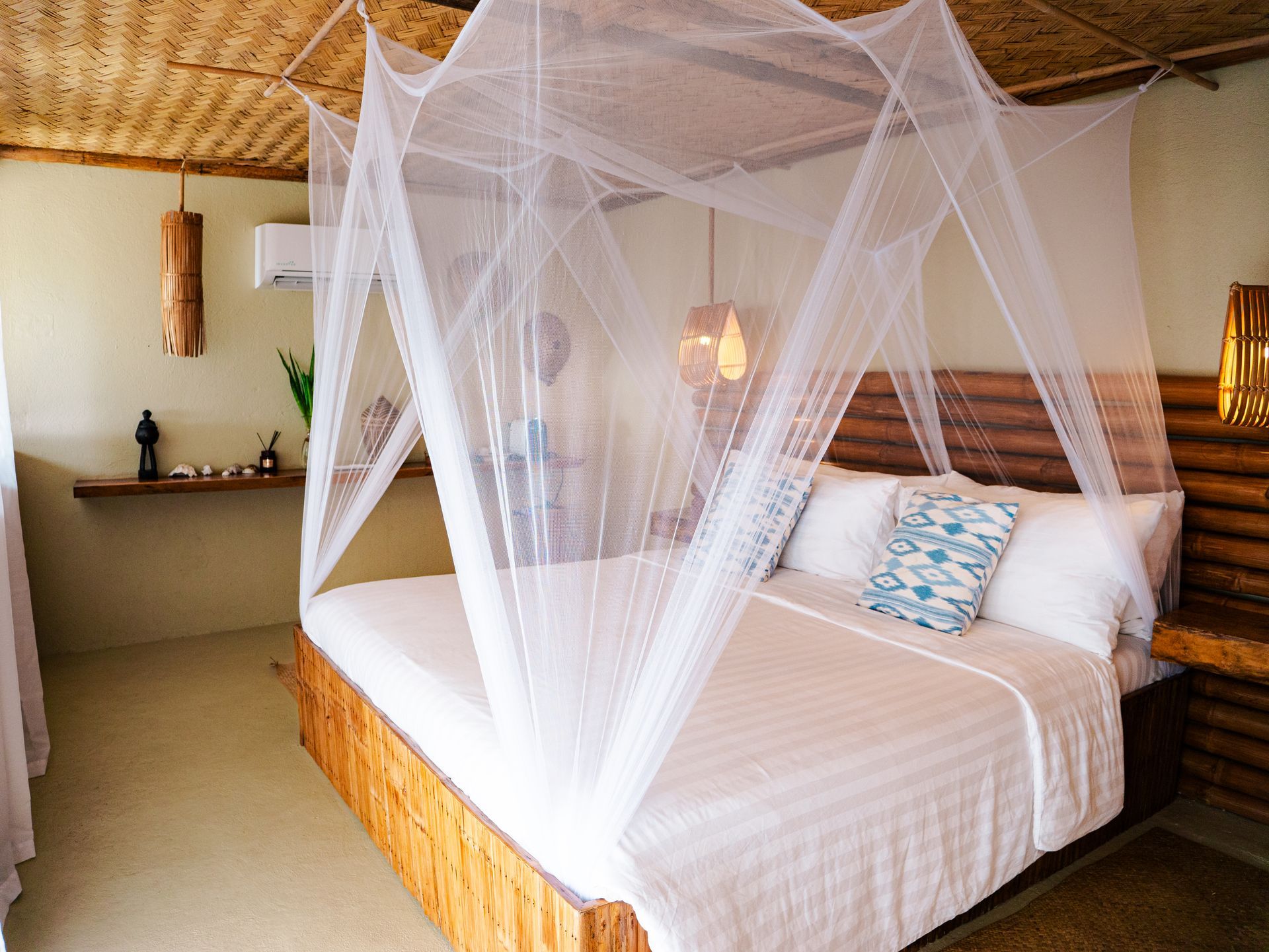 A bedroom with a canopy bed and a mosquito net