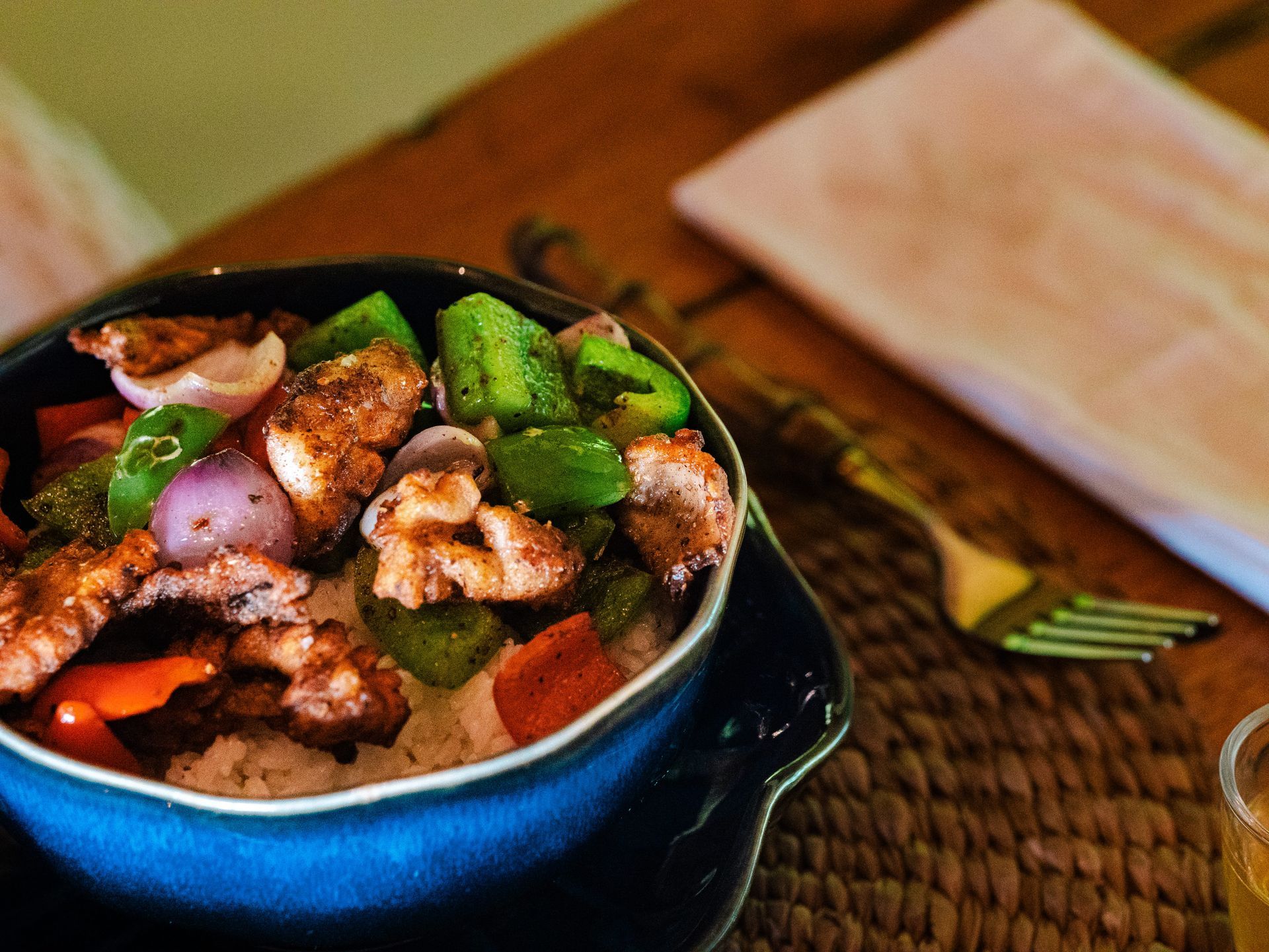 A bowl of food on a table with a fork
