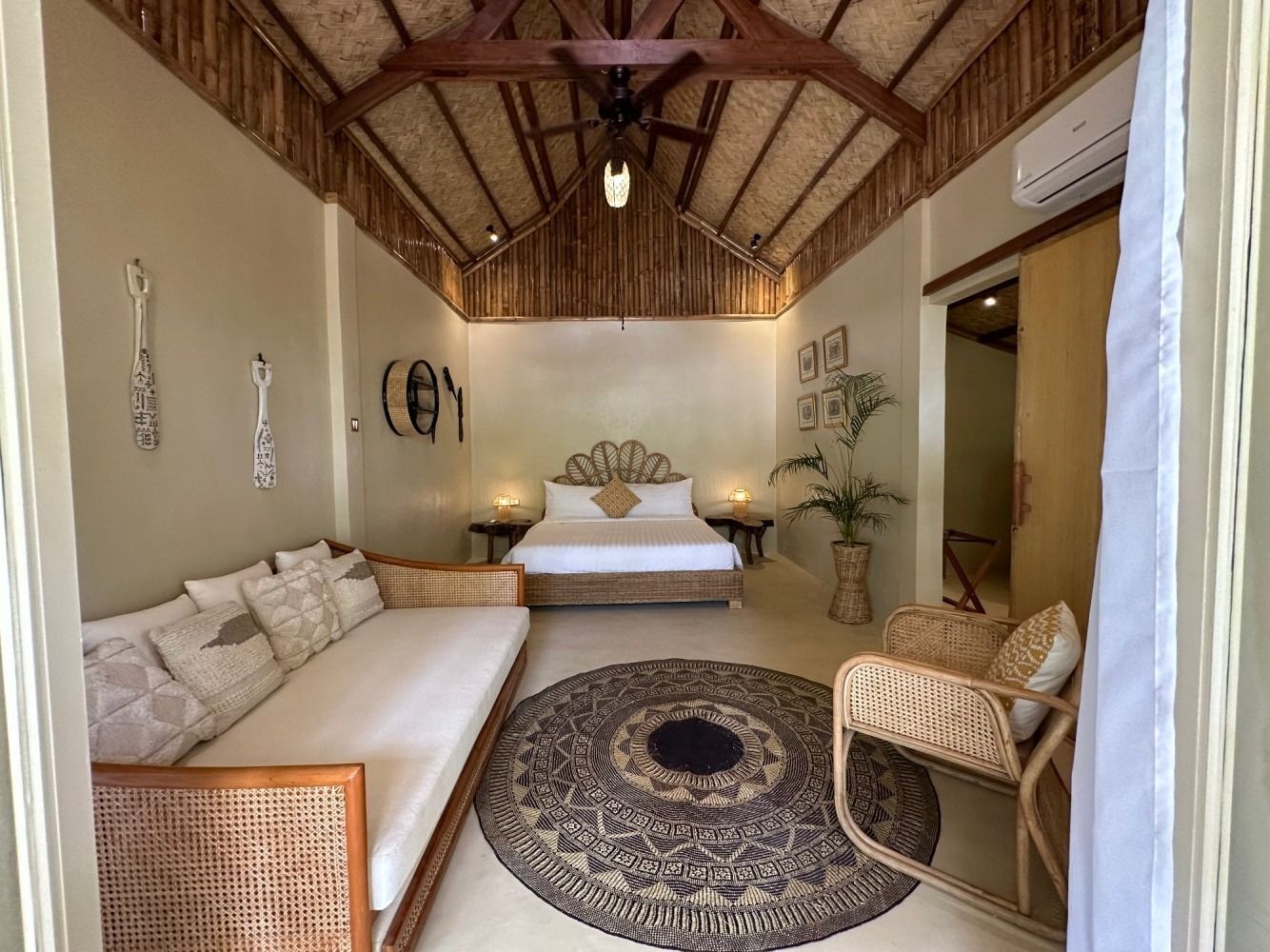 A bedroom with a bed , couch , chair and rug.