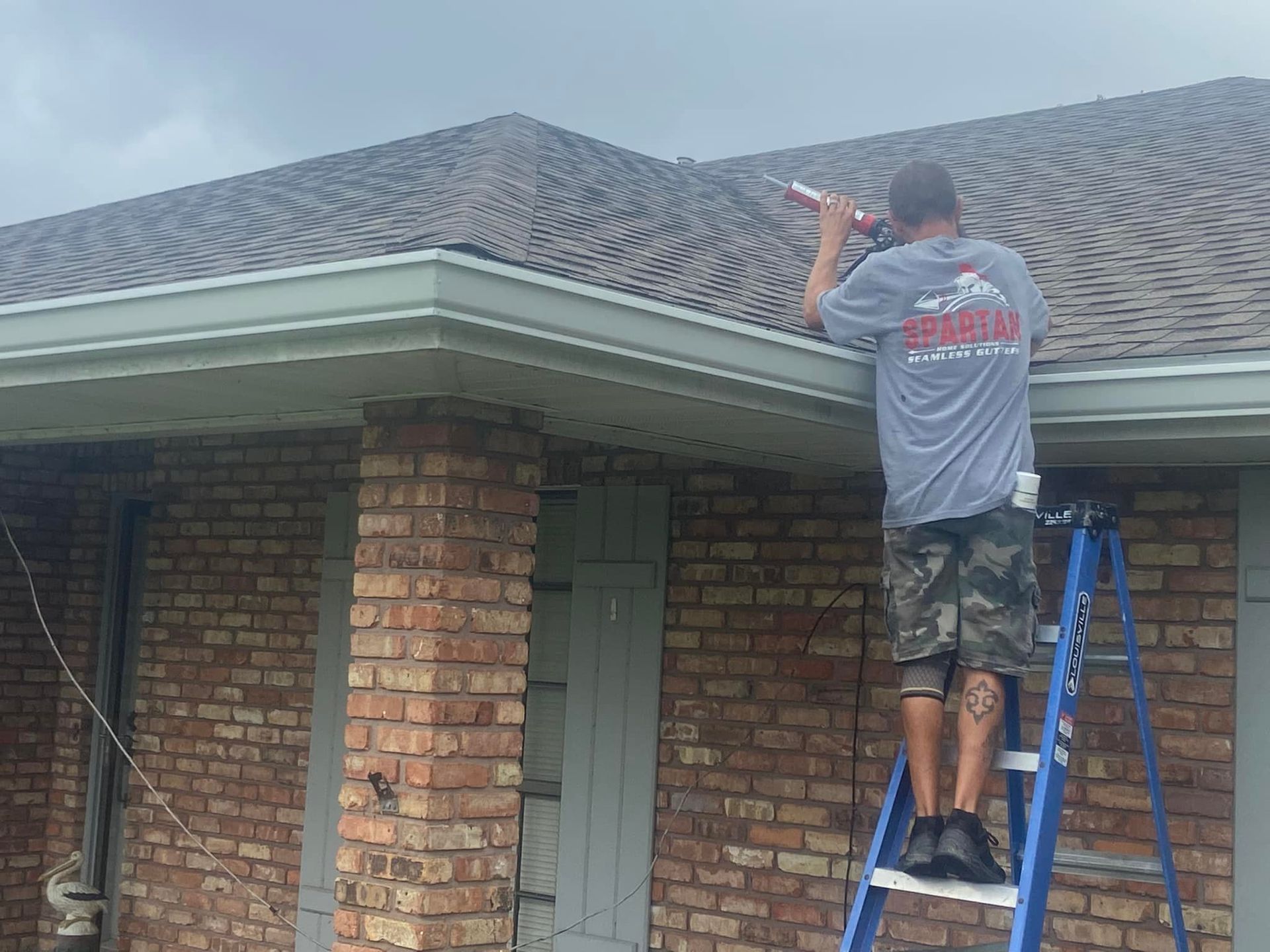 Man Installing Gutter Guard — Raceland, LA — Spartan Home Solutions LLC