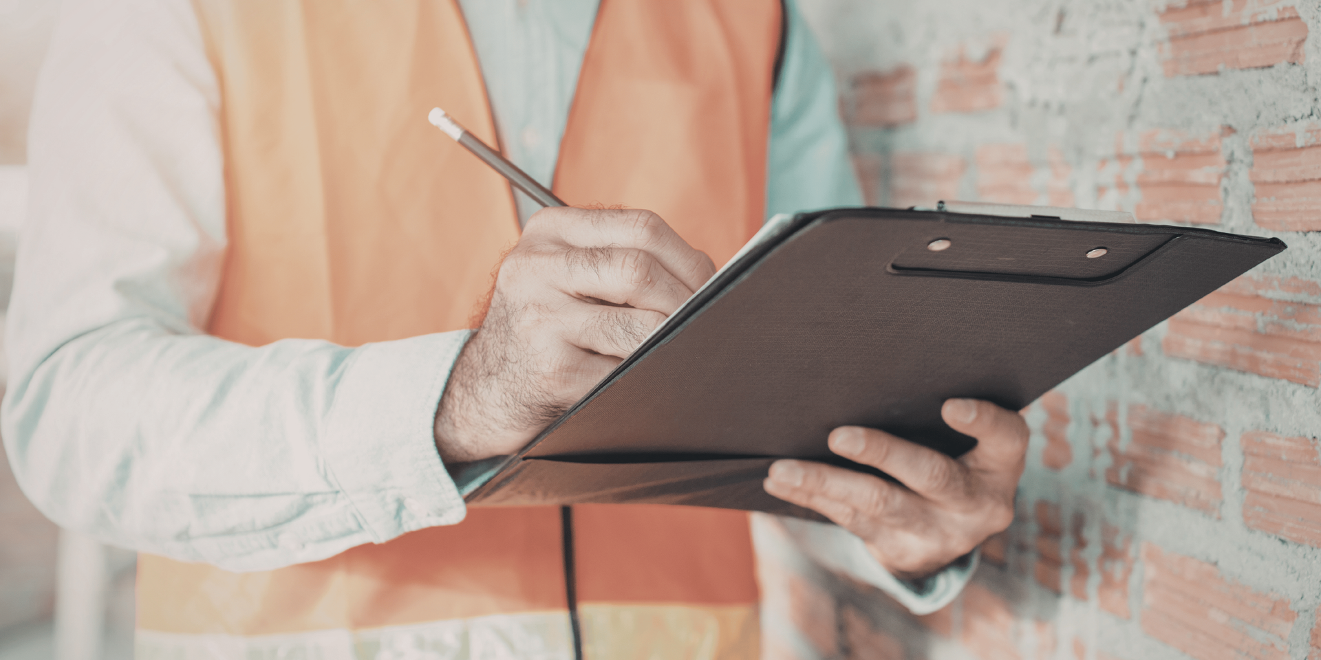 Blue house with red door, small porch, and green landscaping.
