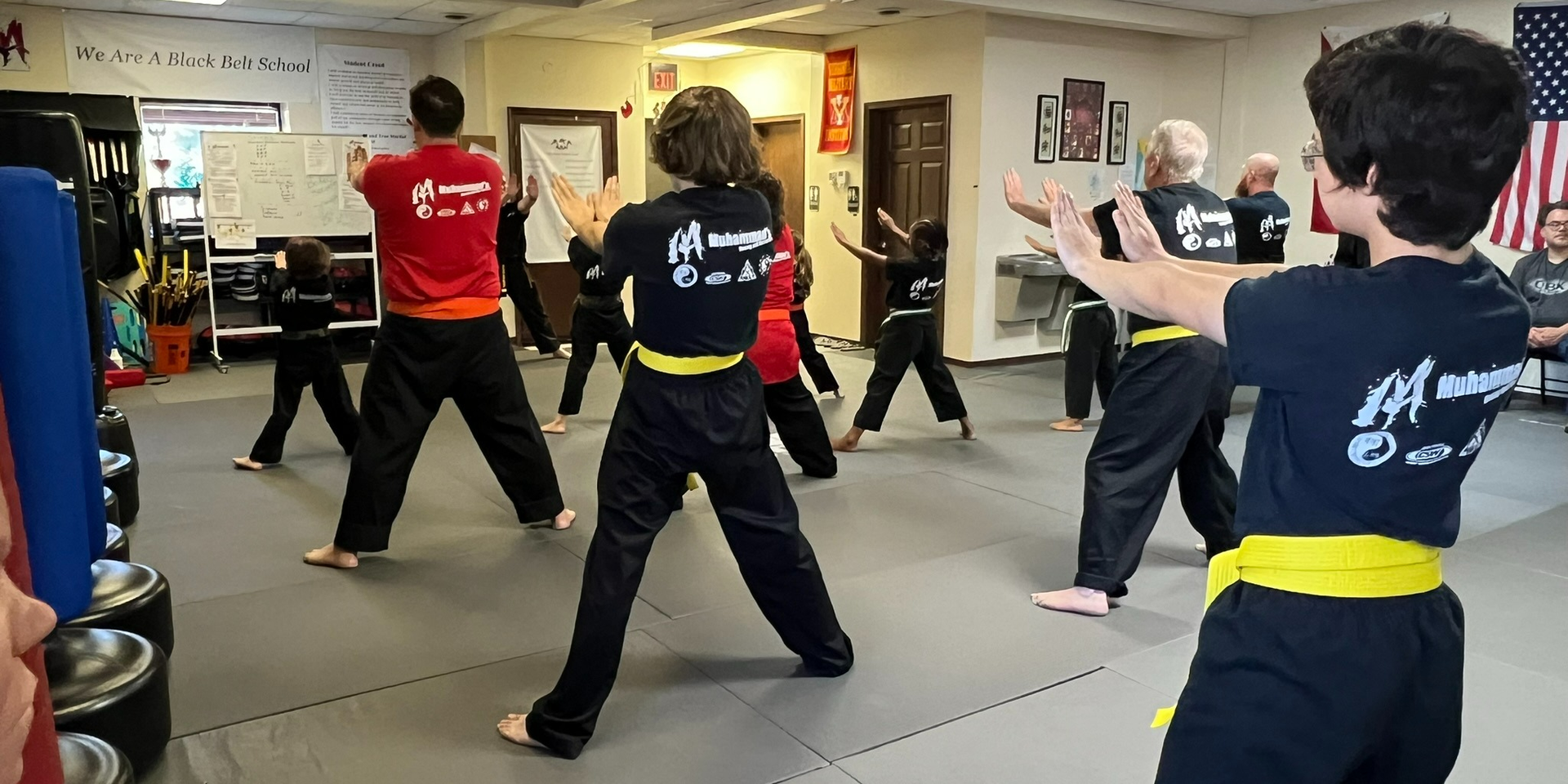 A group of people are practicing martial arts in a gym