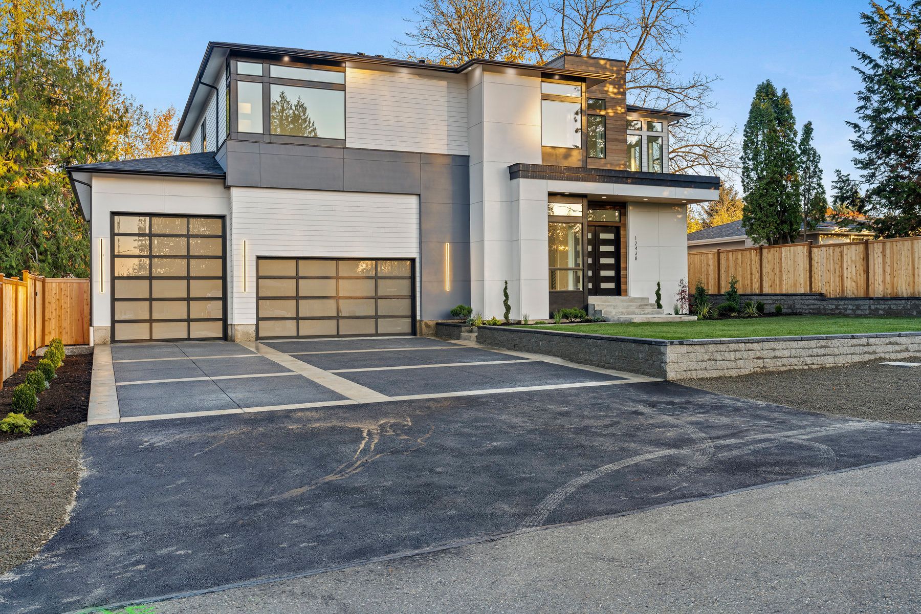 A modern house with a large garage and a driveway.