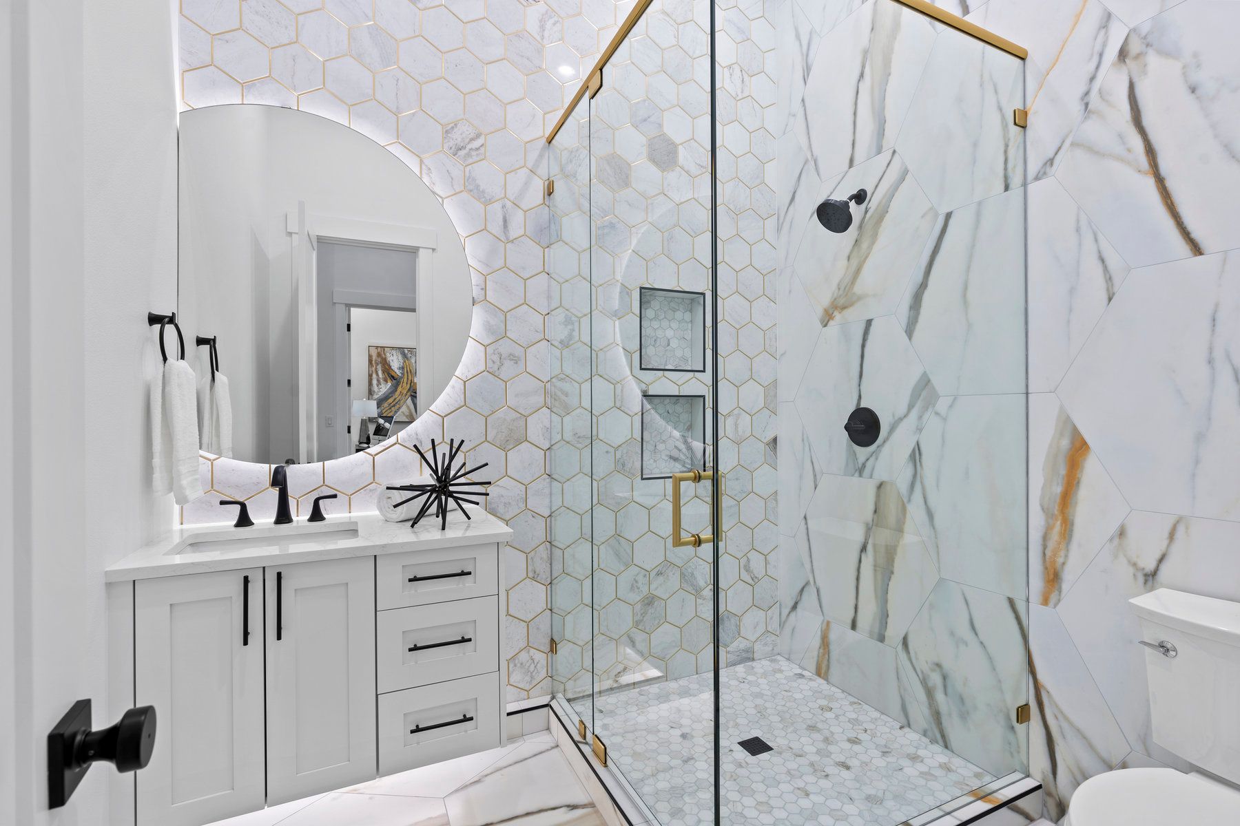 A bathroom with a walk in shower , sink , toilet and mirror.