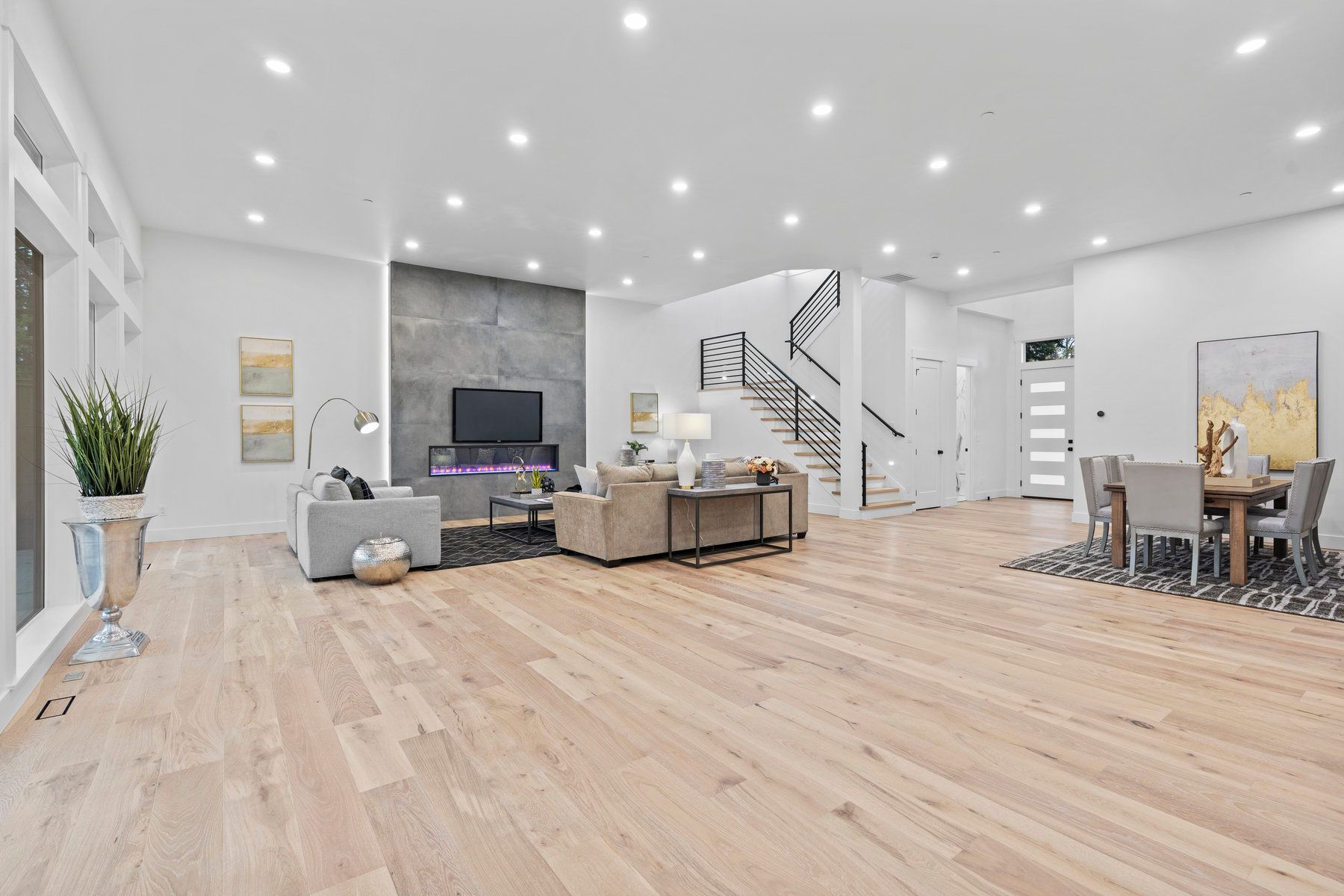 A living room and dining room in a house with hardwood floors.