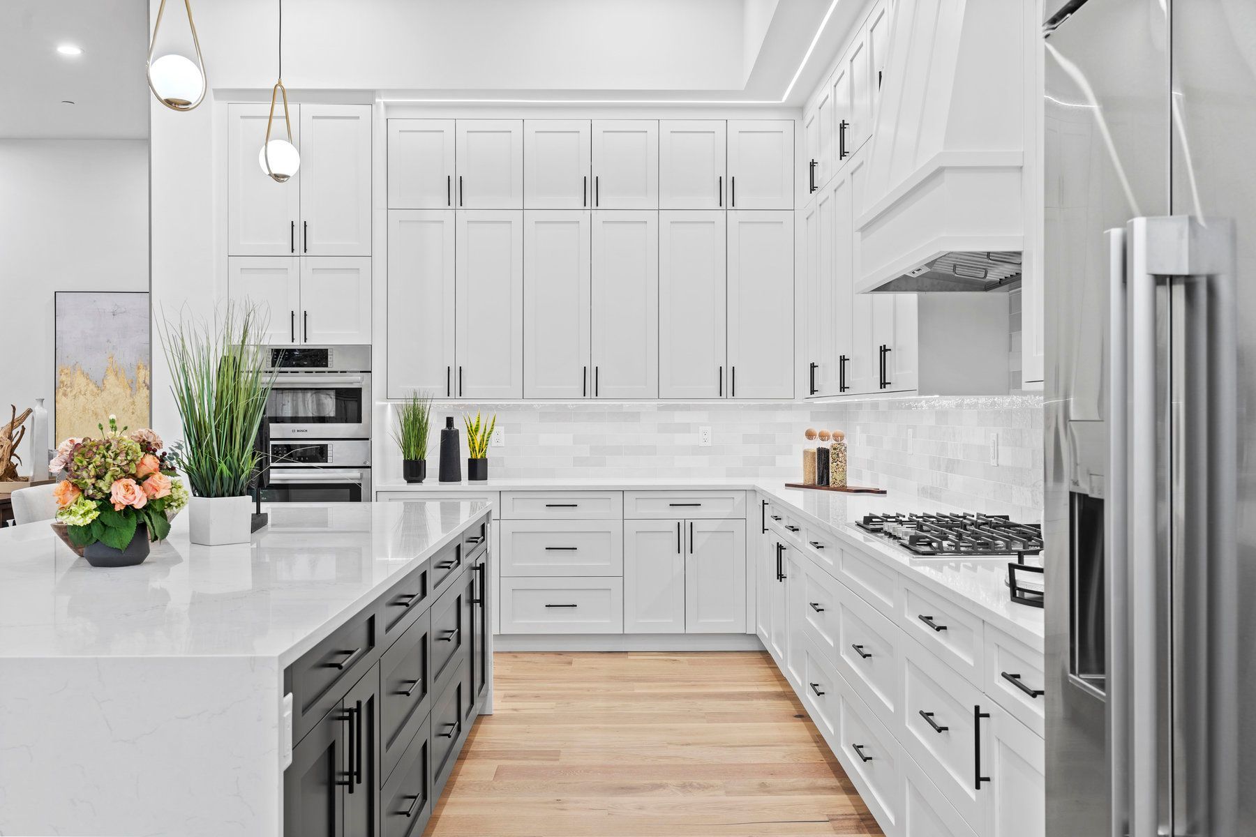 A kitchen with white cabinets and stainless steel appliances.