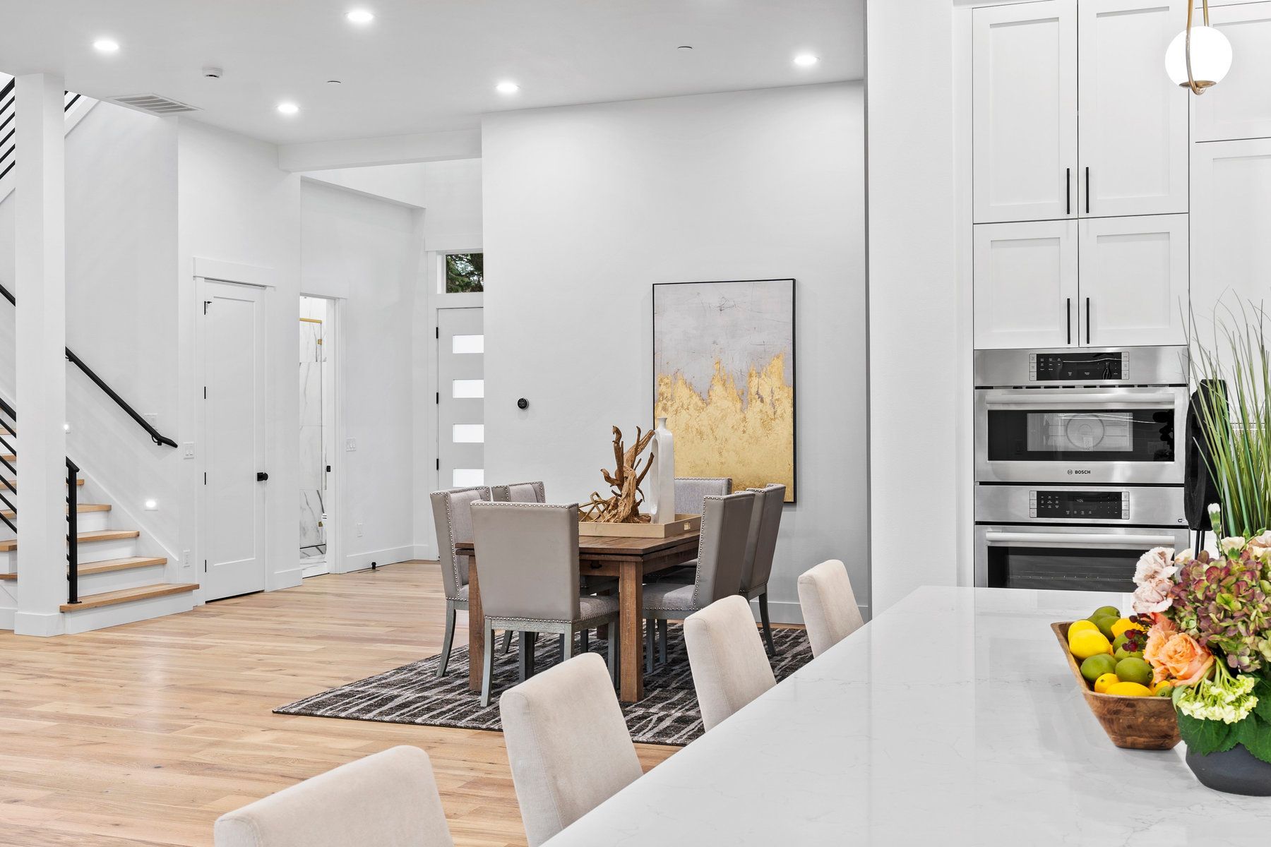 There is a dining room table and chairs in the kitchen.